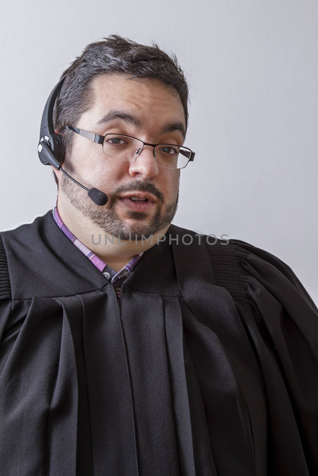 Preacher with headset microphone, in the middle of a speach, against white background
