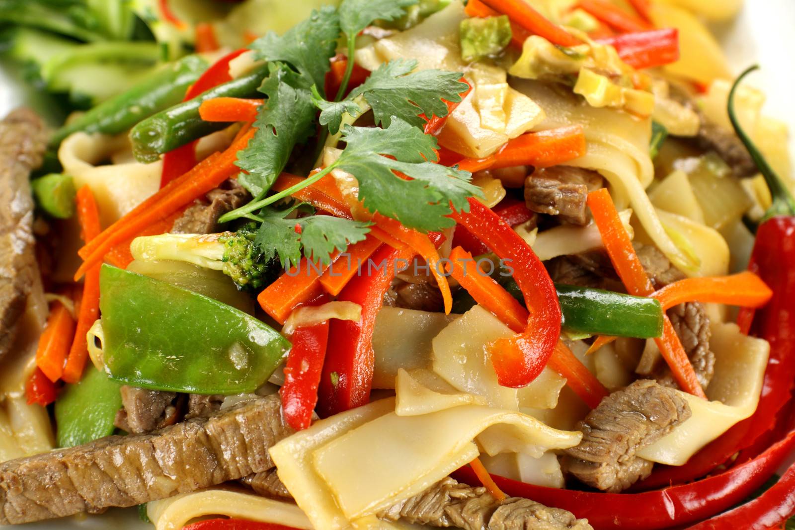 Freshly prepared beef noodle stirfry ready to serve.