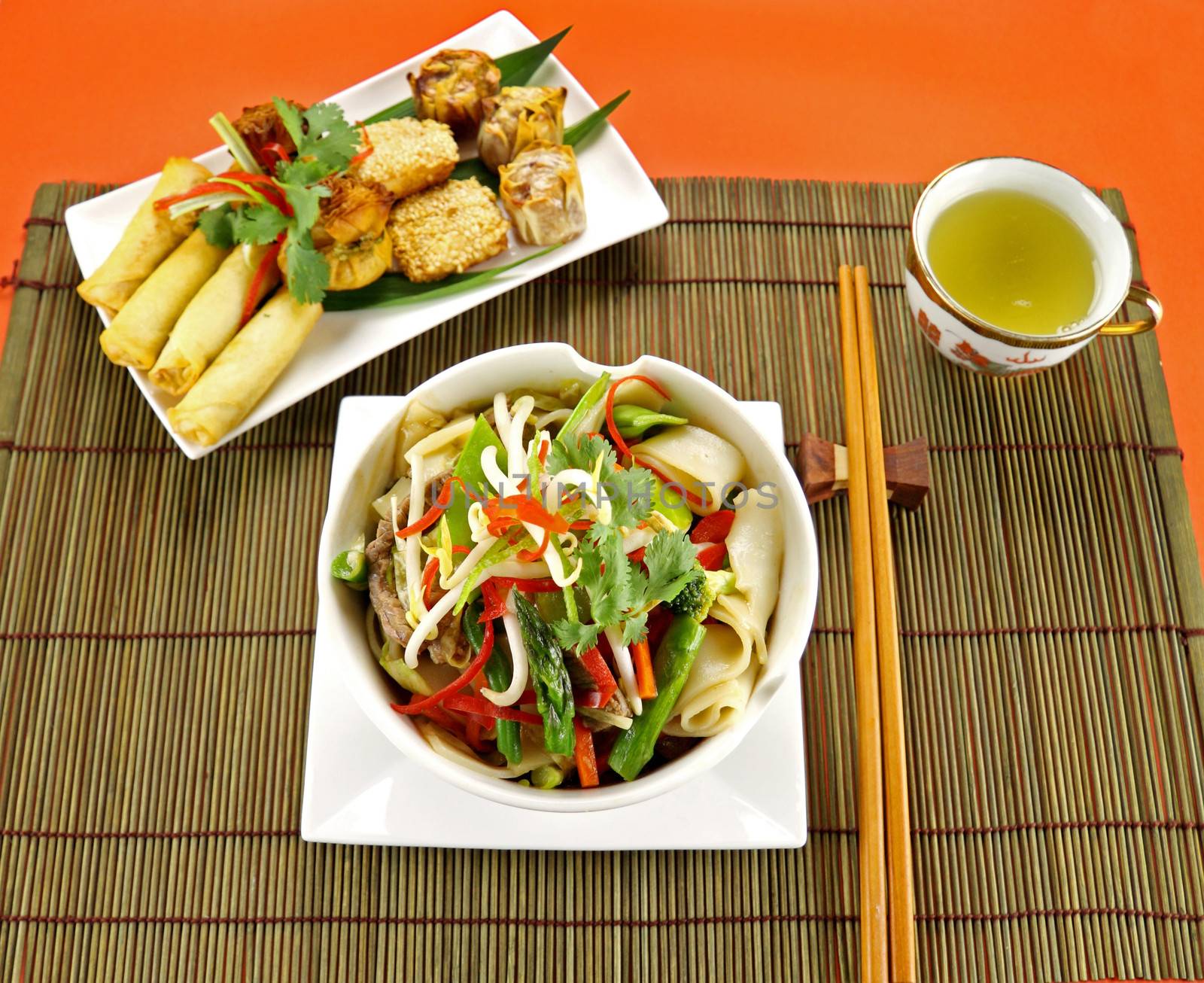 Freshly prepared beef noodle stirfry with dimsums ready to serve.