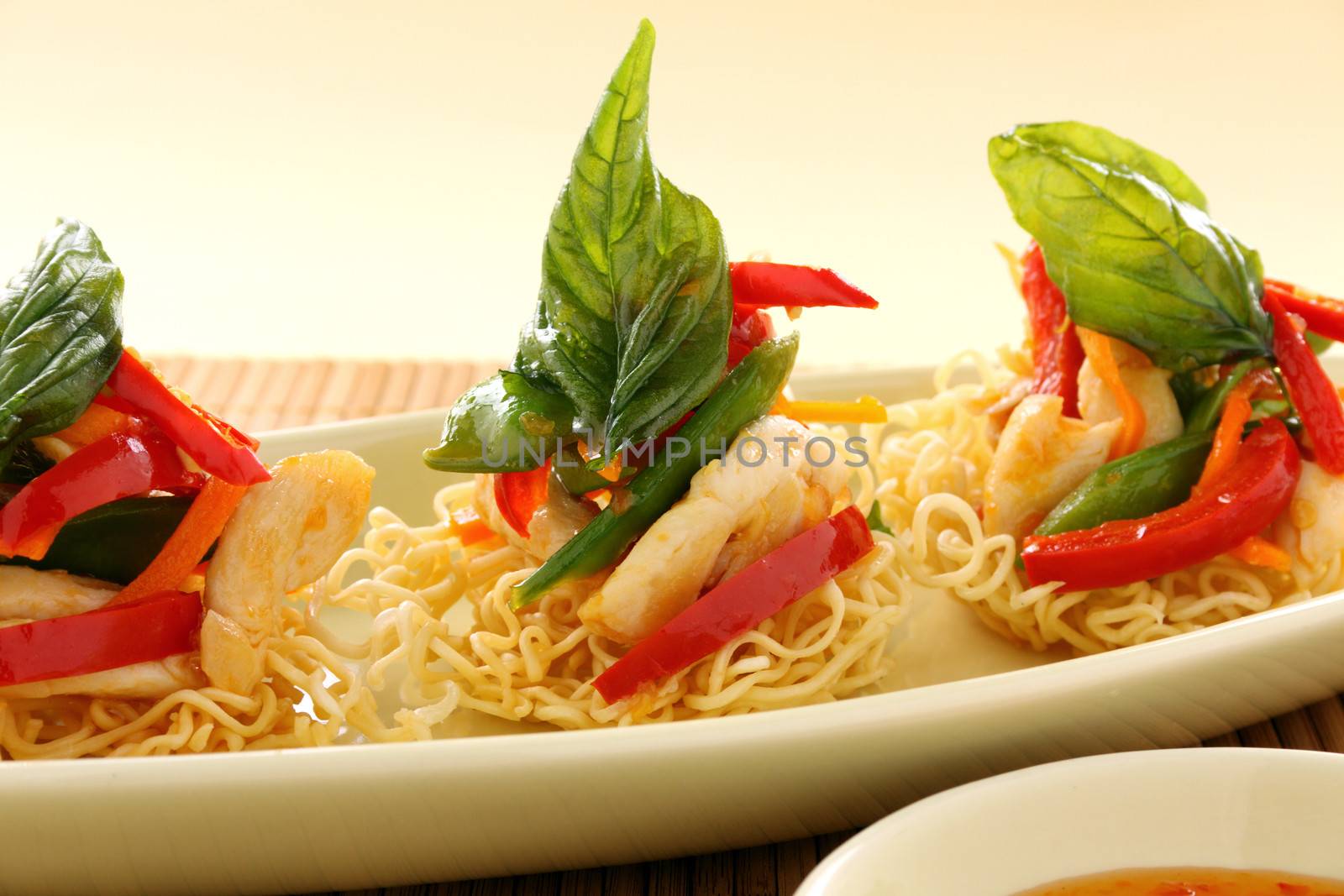 Delicious Asian chilli chicken on beds of crispy noodles.