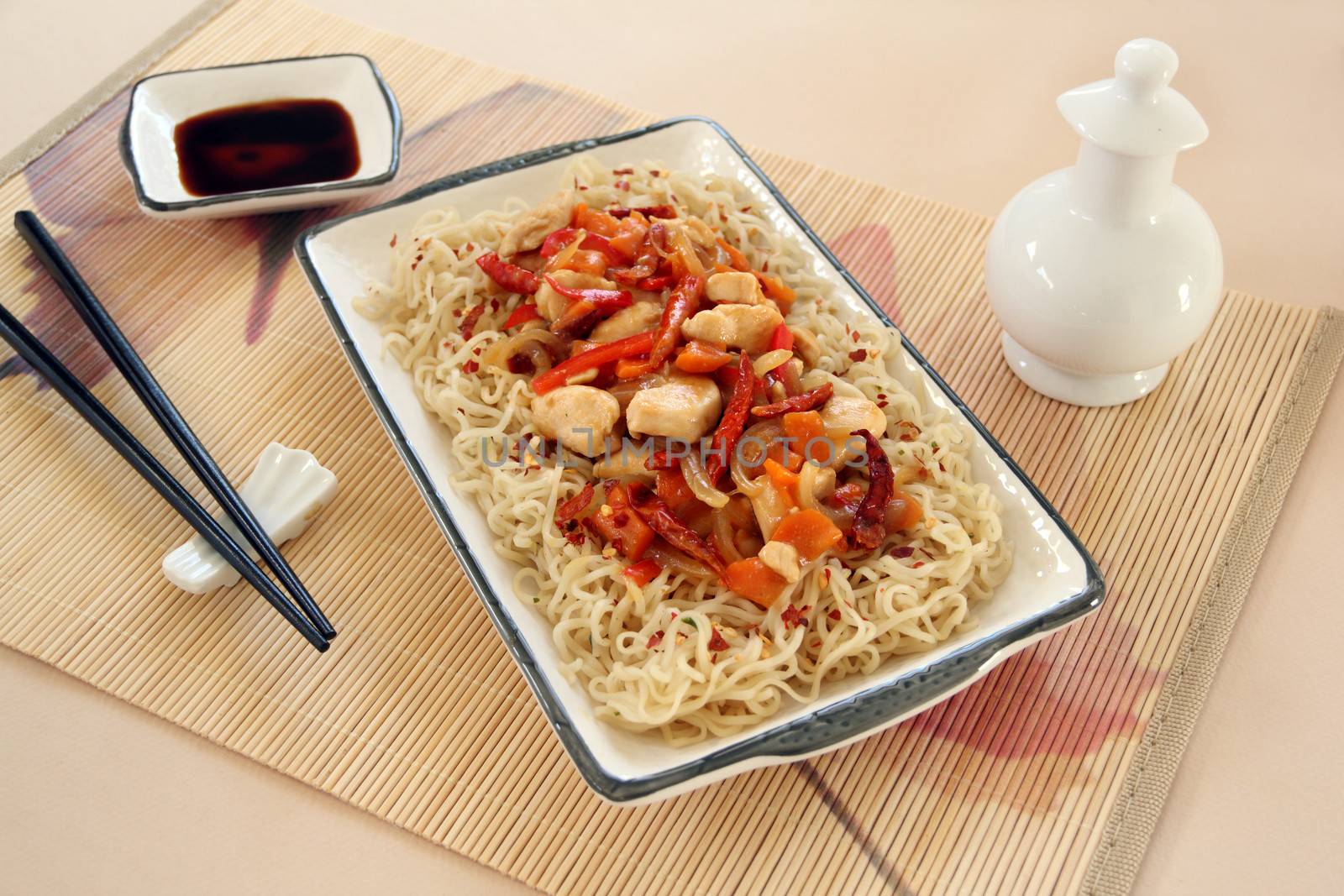 Chilli chicken stirfry with soy sauce condiments ready to serve.