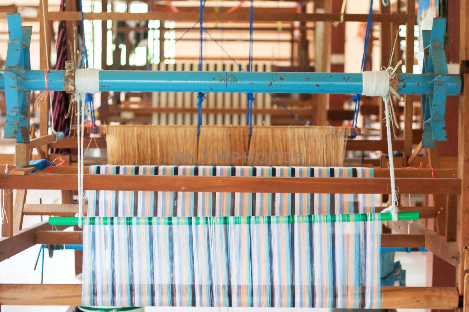Silk weaving on a hand loom in thailand by myrainjom01