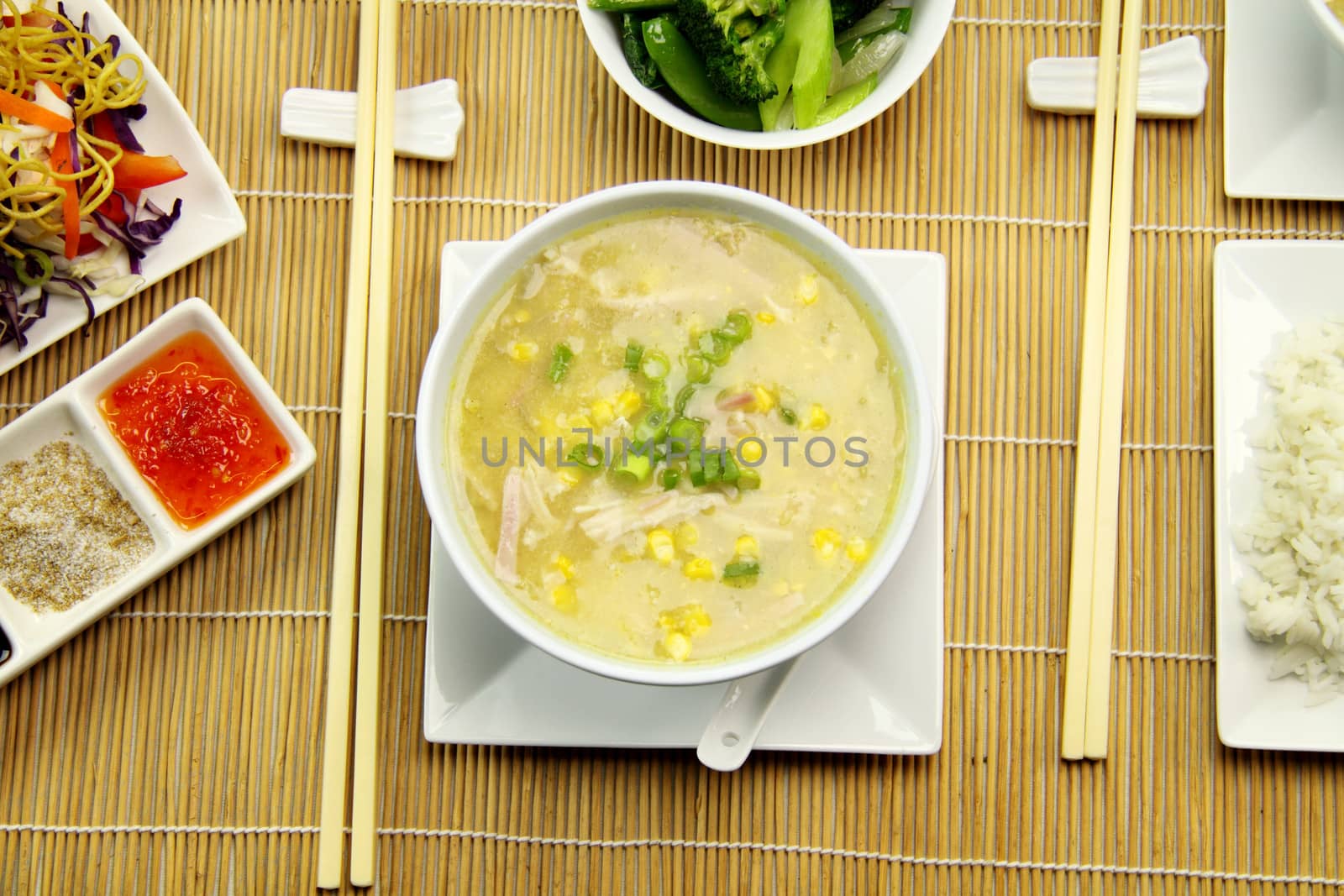 Delicious chicken and corn soup with asian vegetables and noodles.