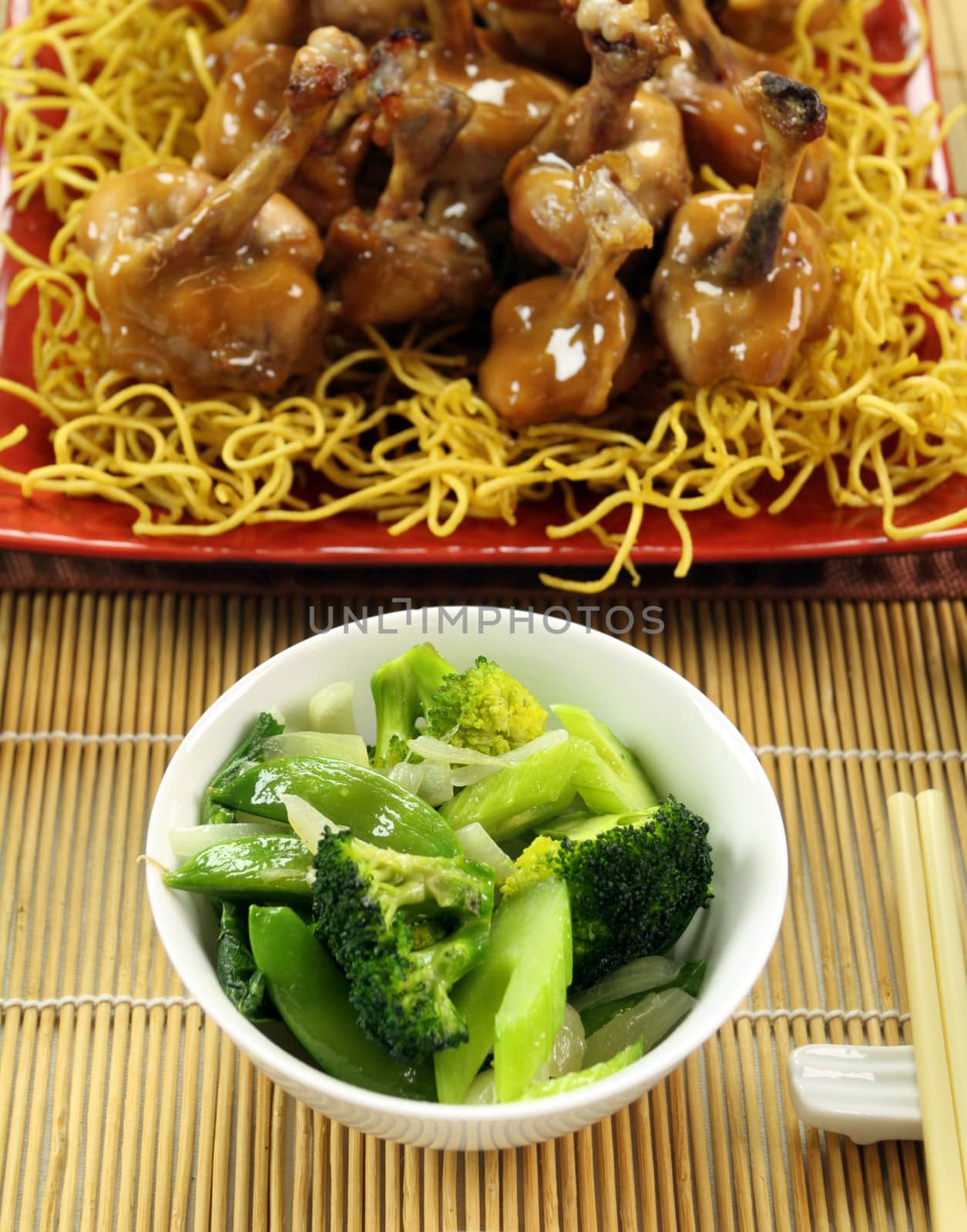 Asian green vegetables with mini chicken drumsticks.