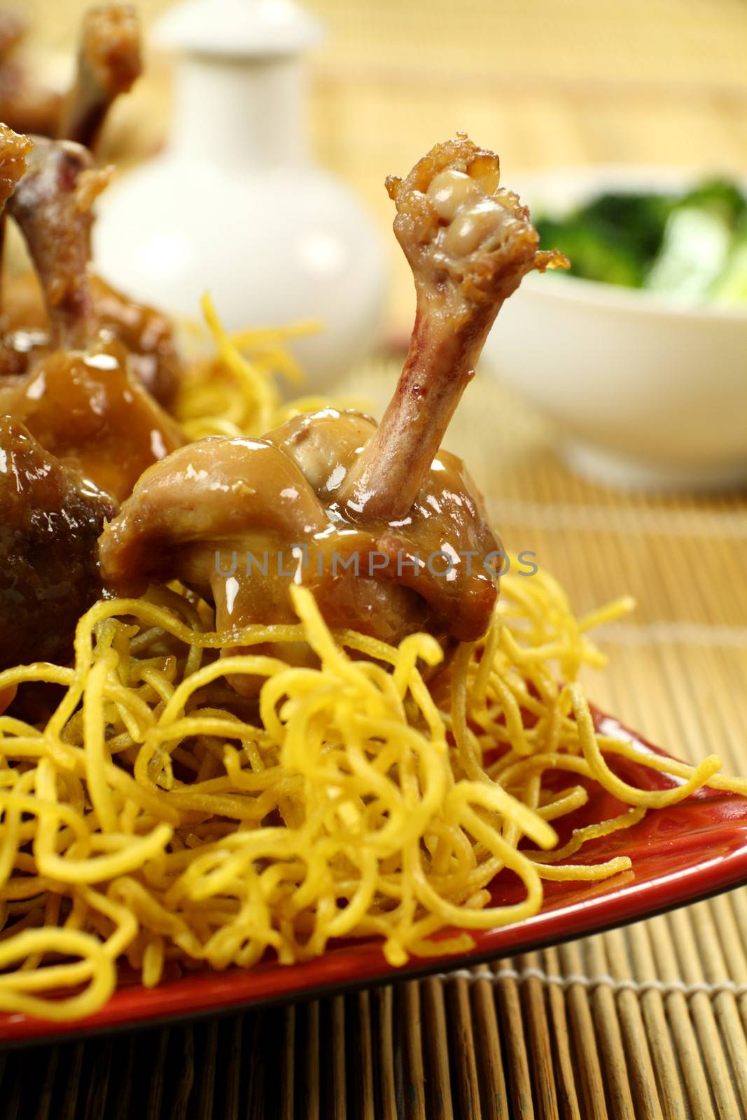 Delicious chicken drumettes on a bed of noodles.