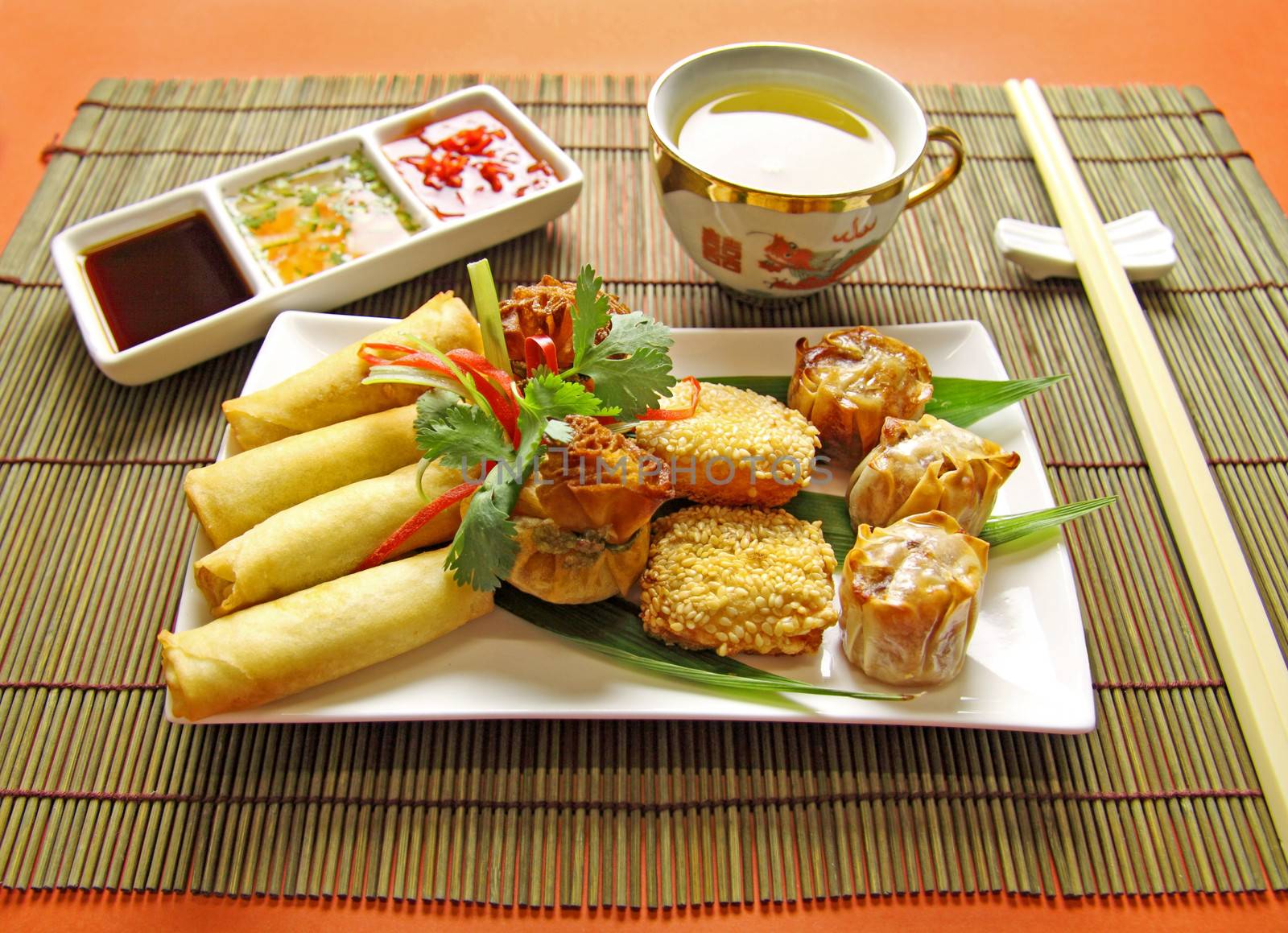 Delicious dim sims, sesame shrimp toasts and spring rolls ready to serve.