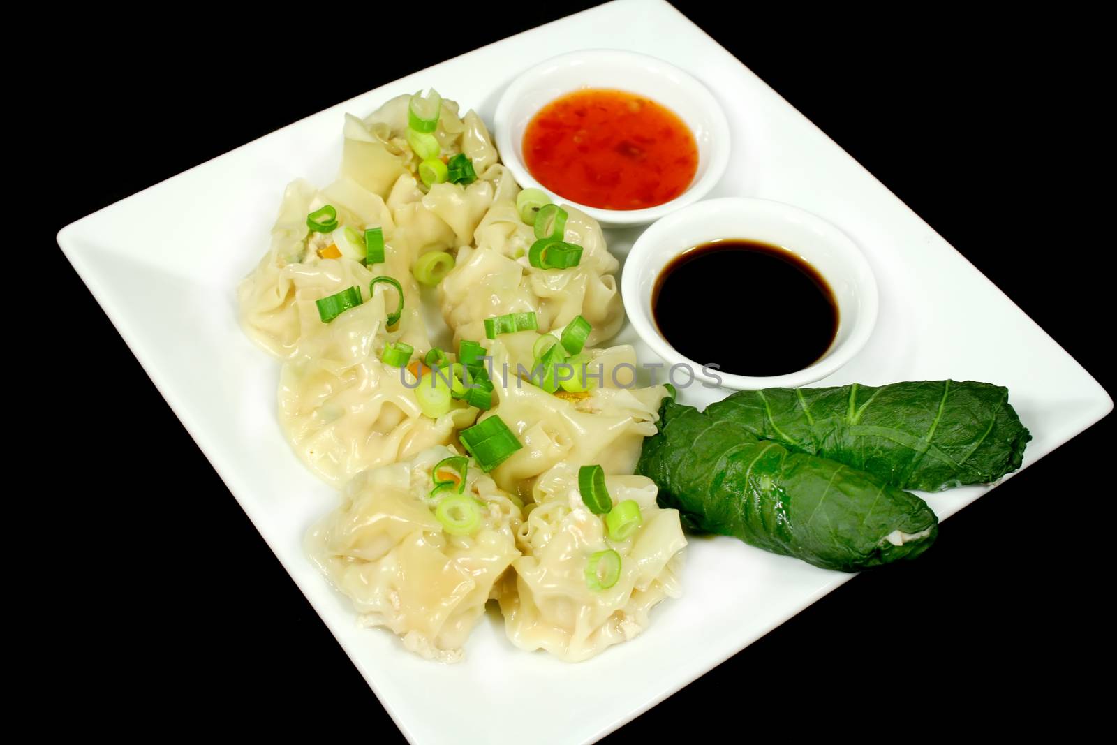 Steamed dim sums and cabbage rolls ready to serve.