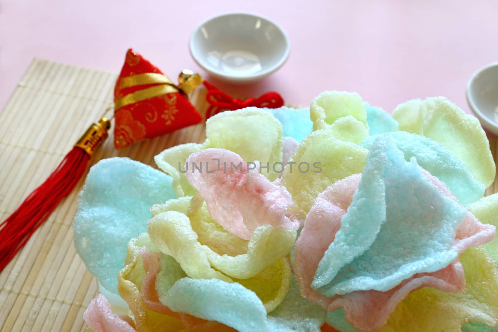 Delicious crispy Asian prawn crackers with spearmint leaves ready to serve.