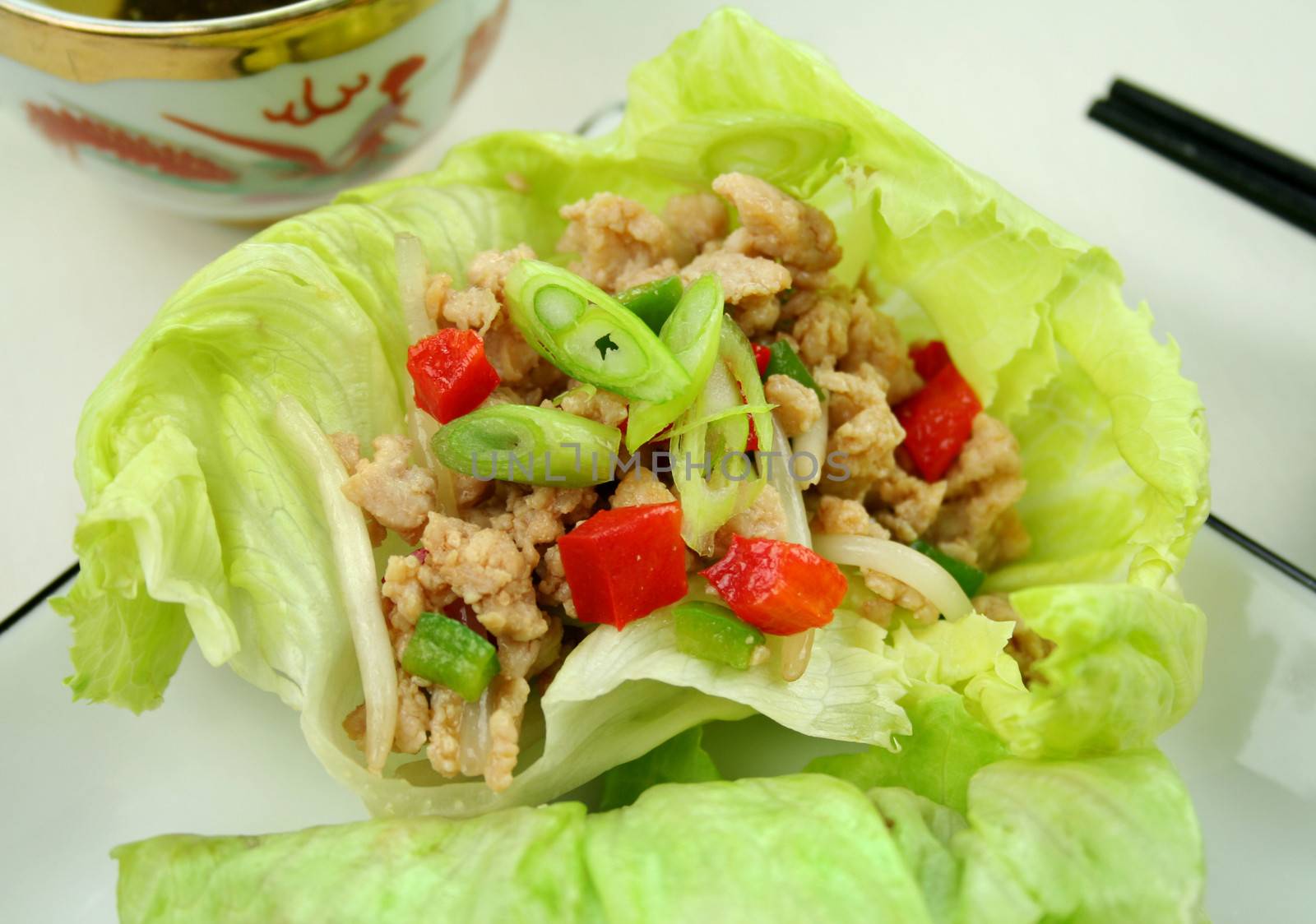 Delicious San Choy Bow with minced chicken and Chinese vegetables wrapped in fresh lettuce leaves.