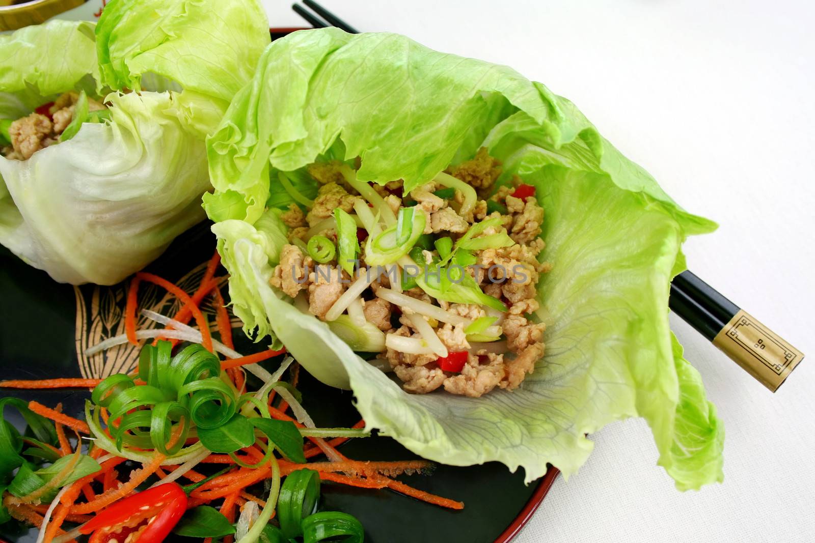 Delicious San Choy Bow with minced chicken and Chinese vegetables wrapped in fresh lettuce leaves.