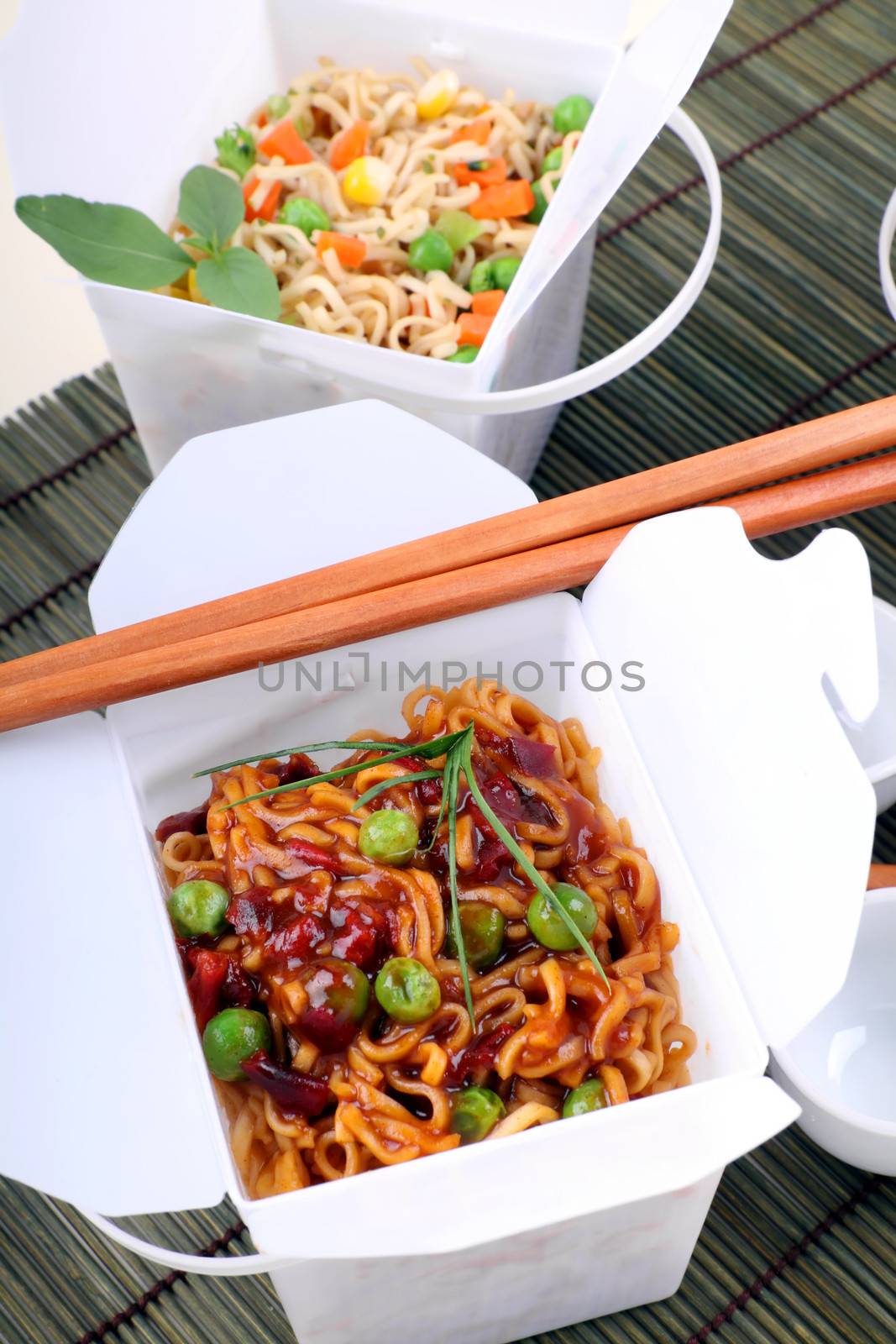 BBQ egg noodles and vegetable noodles in take away containers.