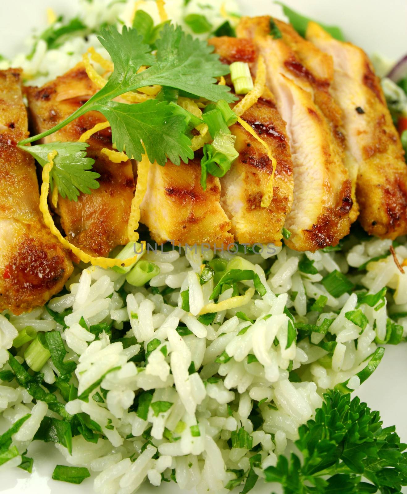 Delicious chicken tikka on a bed of lemon coriander rice with salad.