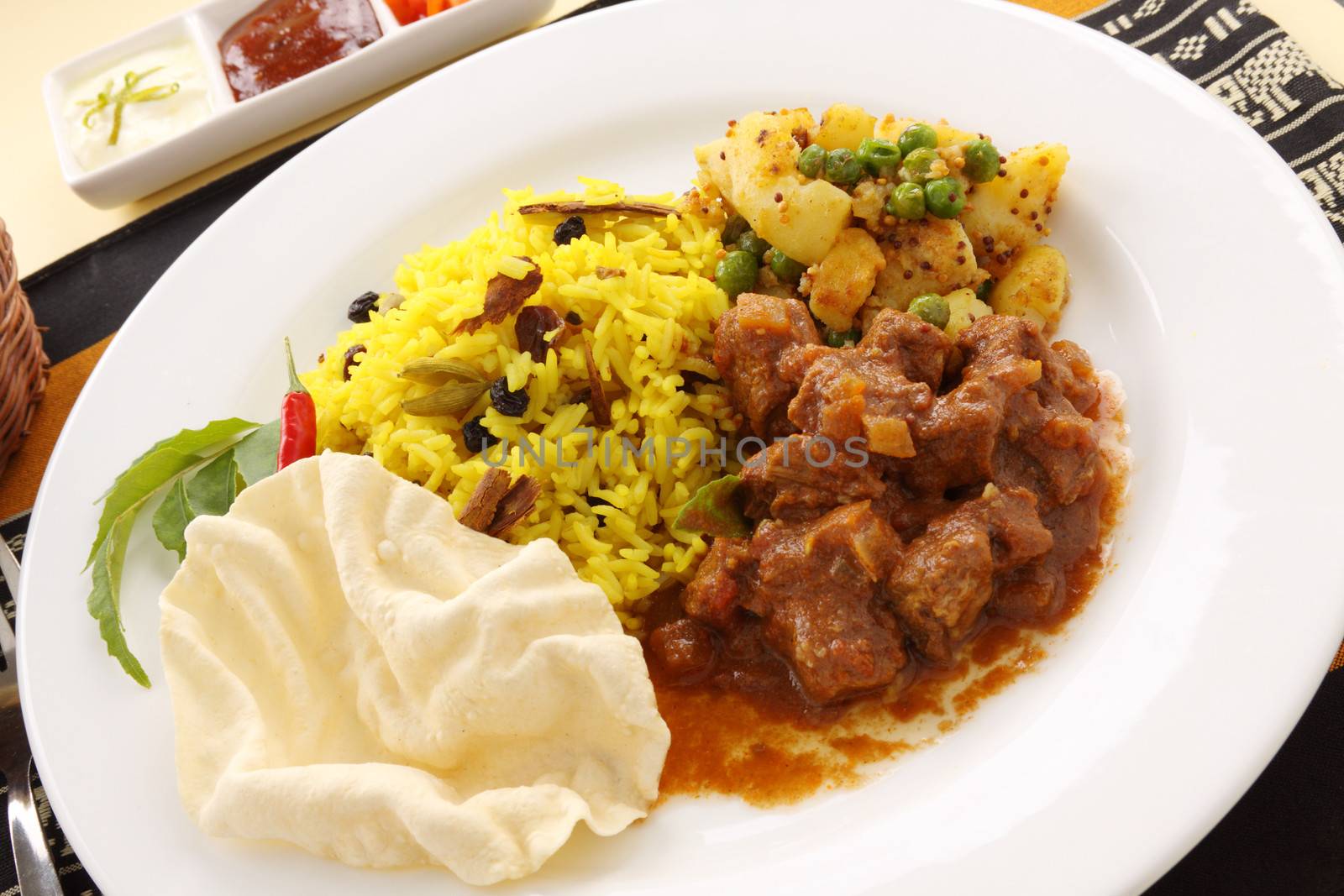 Delicious and spicy Indian beef curry served with pappadums.