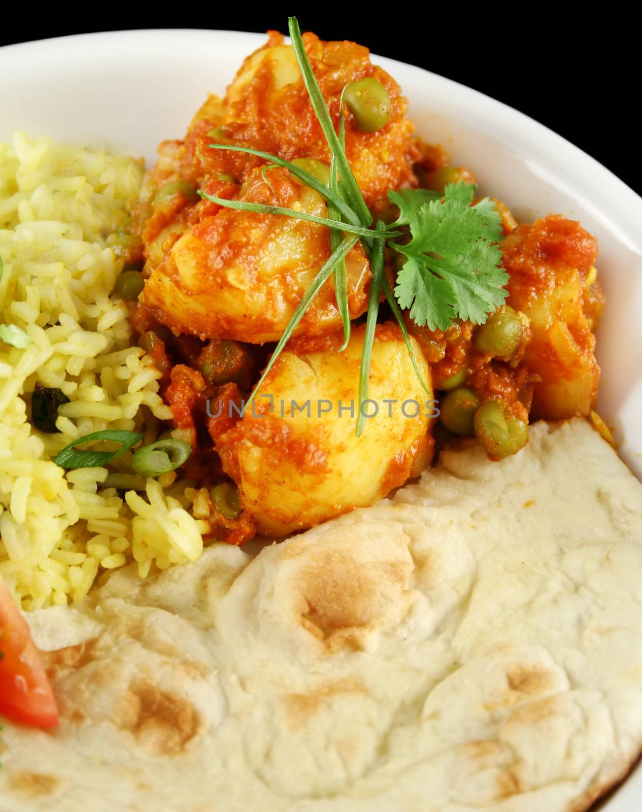 Indian pea and potato curry with tumeric rice and a side salad.