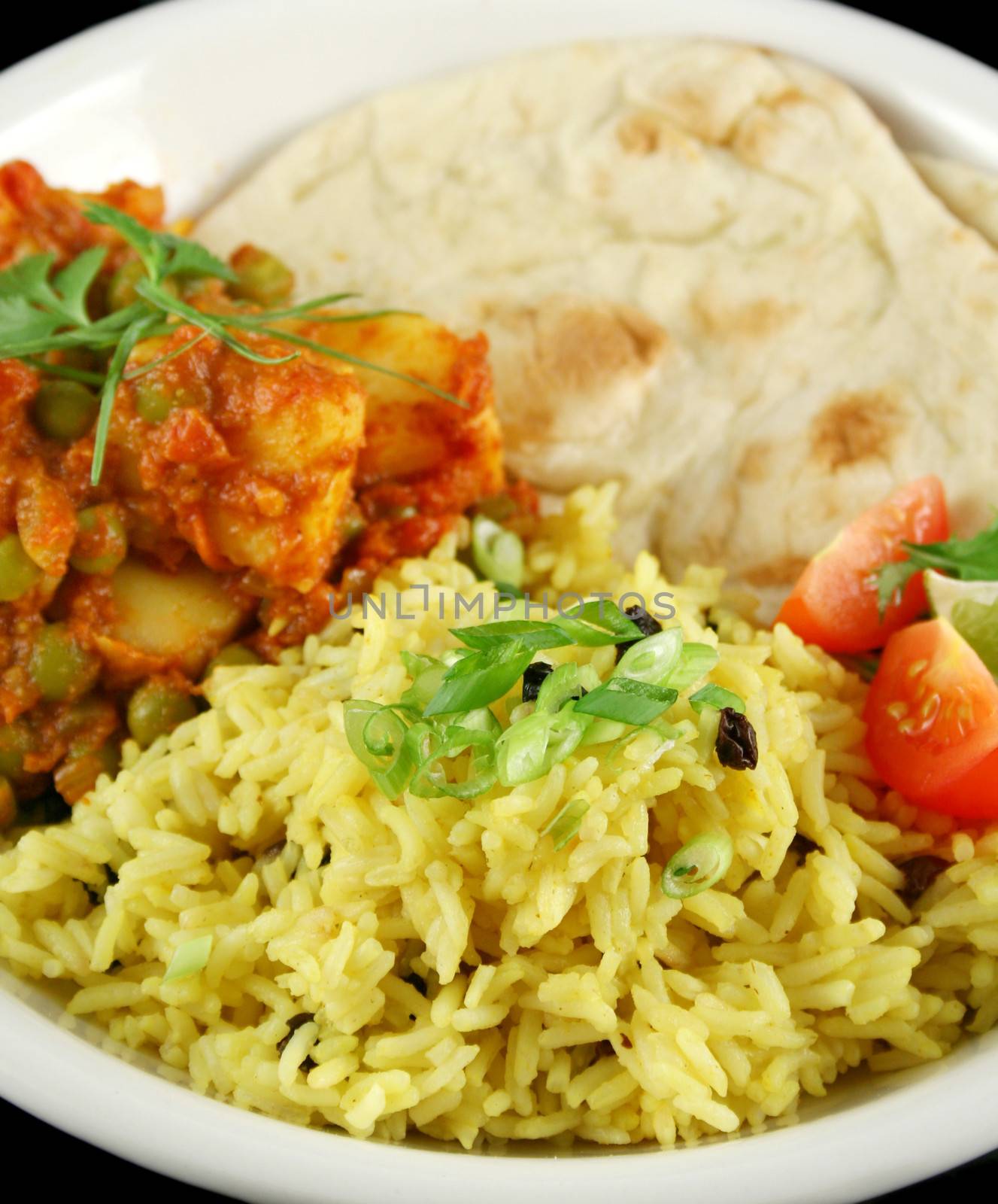 Indian pea and potato curry with tumeric rice and a side salad.