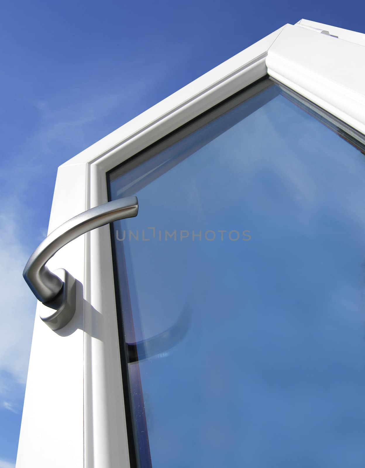 White window with silver handle with blue sky in the background