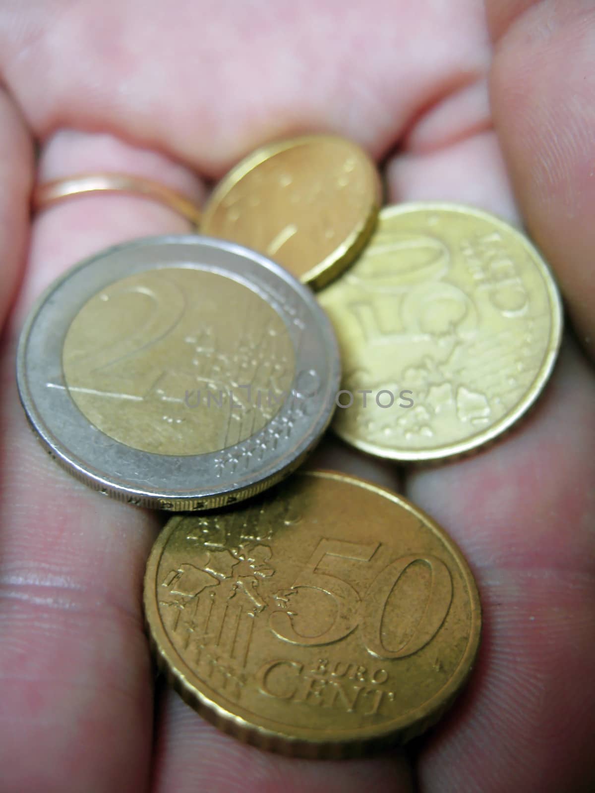Euro coin and euro cents on the male hand
