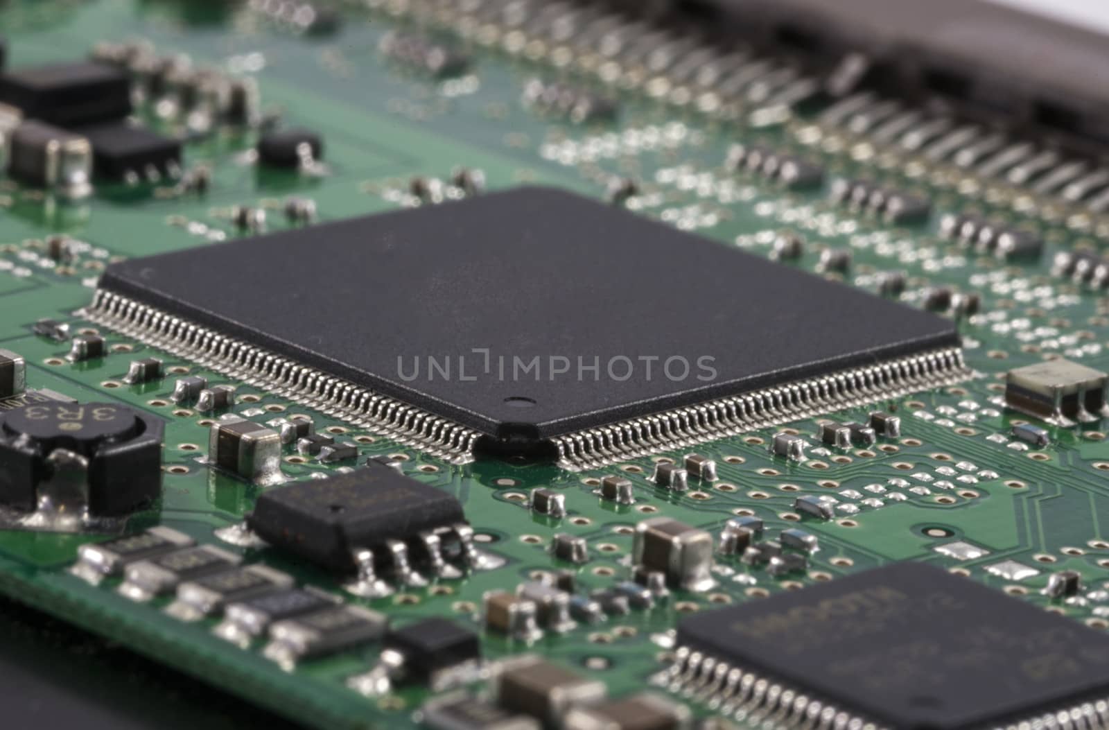 Green Electrical Circuit Board with microchips, conductors, and transistors