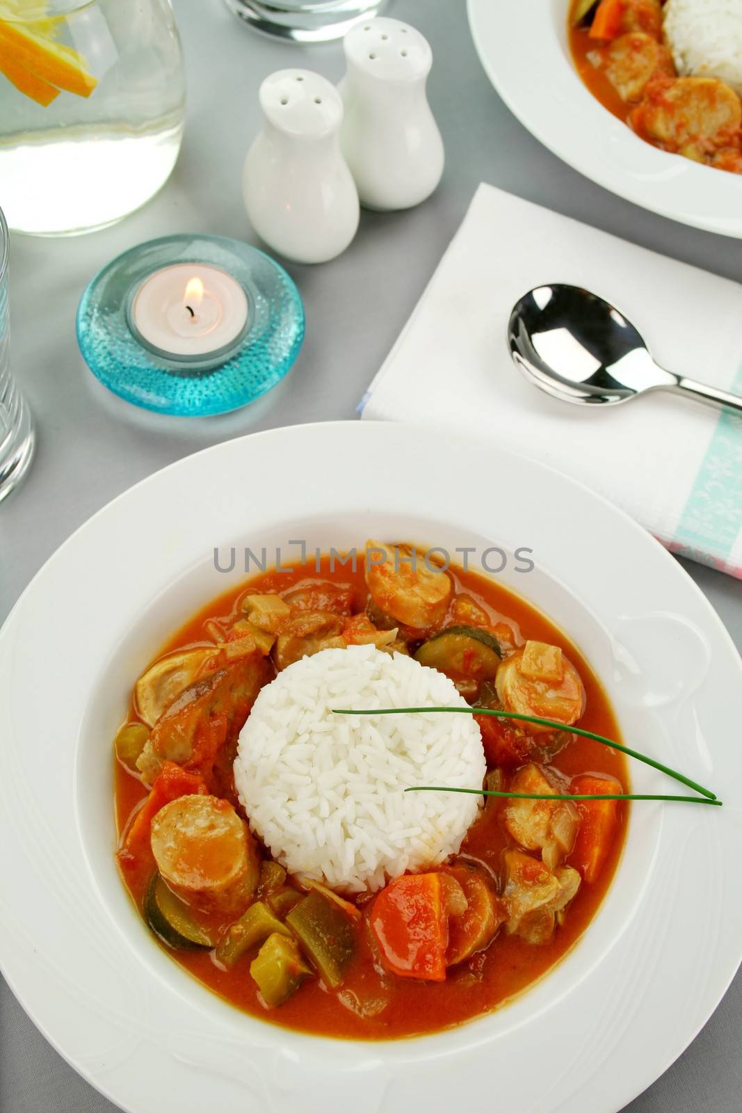 Delicious chicken gumbo with rice, sausage, peppers, onions, carrots and tomatoes.