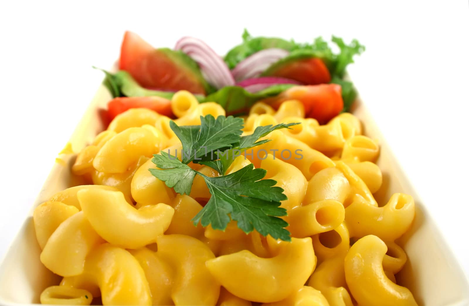 Macaroni cheese and a fresh garden salad ready to serve.