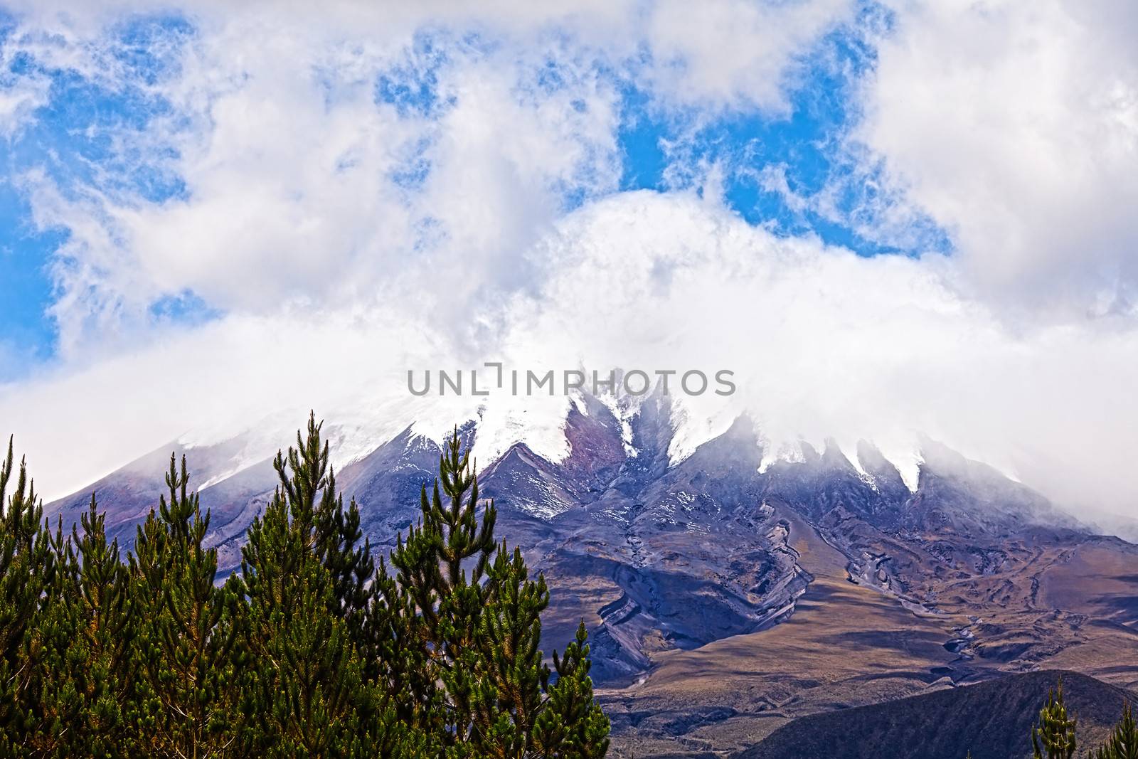 Cotopaxi Volcano in the background of blue sky and clouds