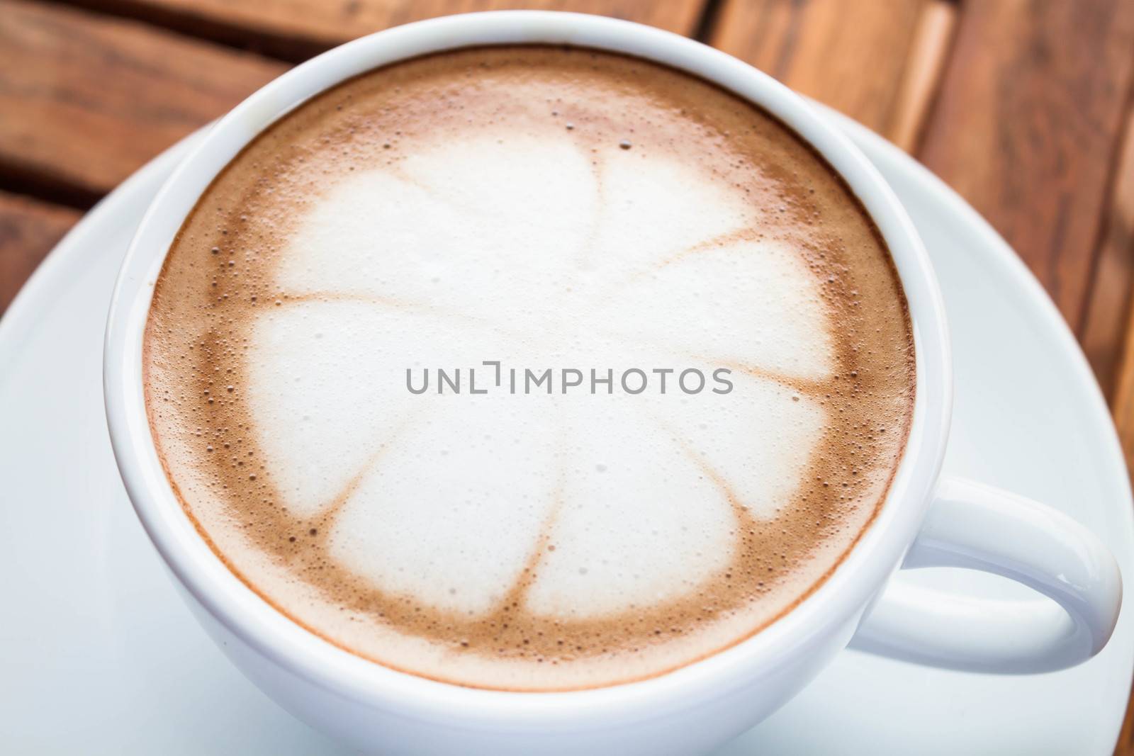 Hot cafe mocha cup with milk microfoam on topped by punsayaporn