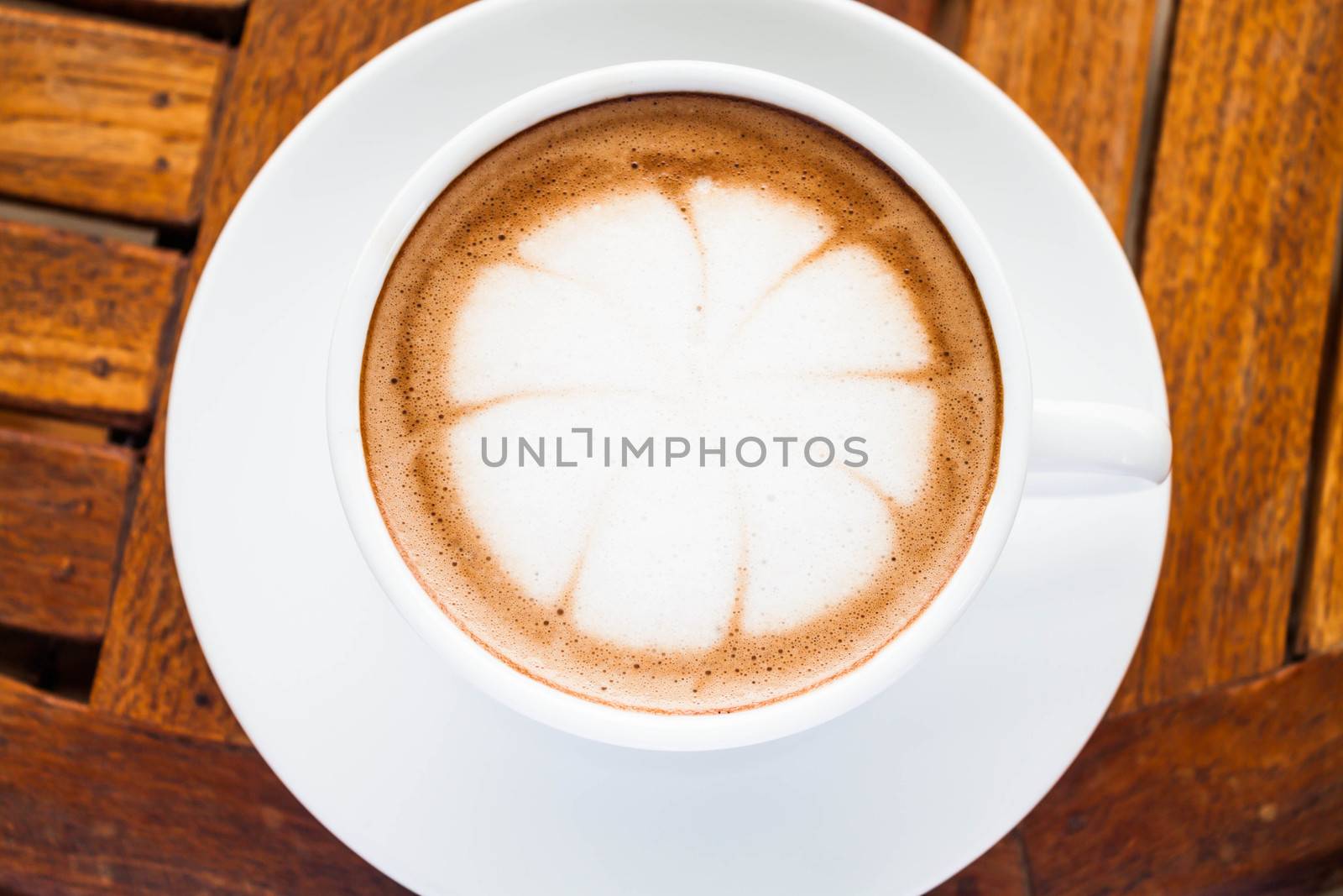 Beautiful cup of hot cafe mocha on wooden table by punsayaporn