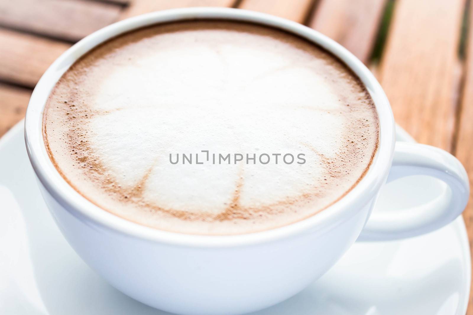 Serving cup of hot cafe mocha on wooden table