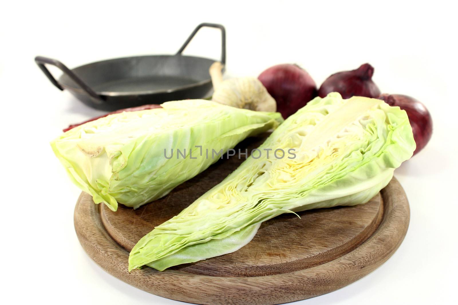 a sliced sweetheart cabbage on a wooden board