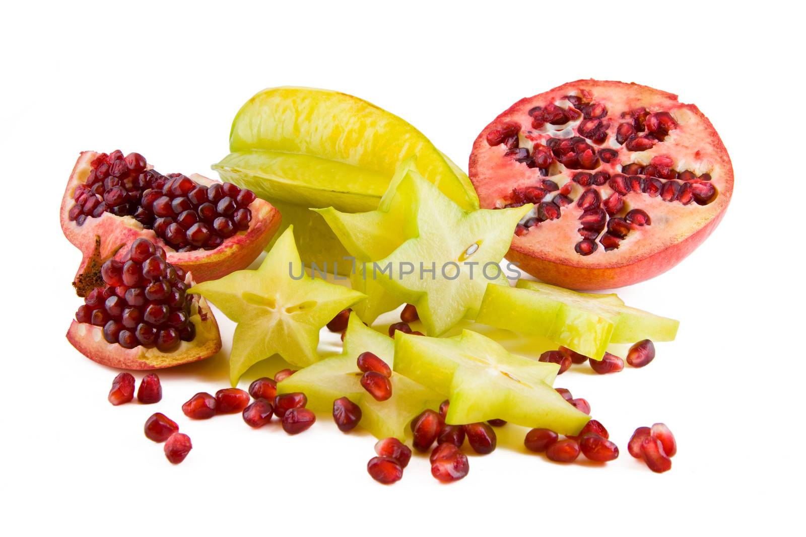 Fresh pomegranate and carambola fruits isolated on white background