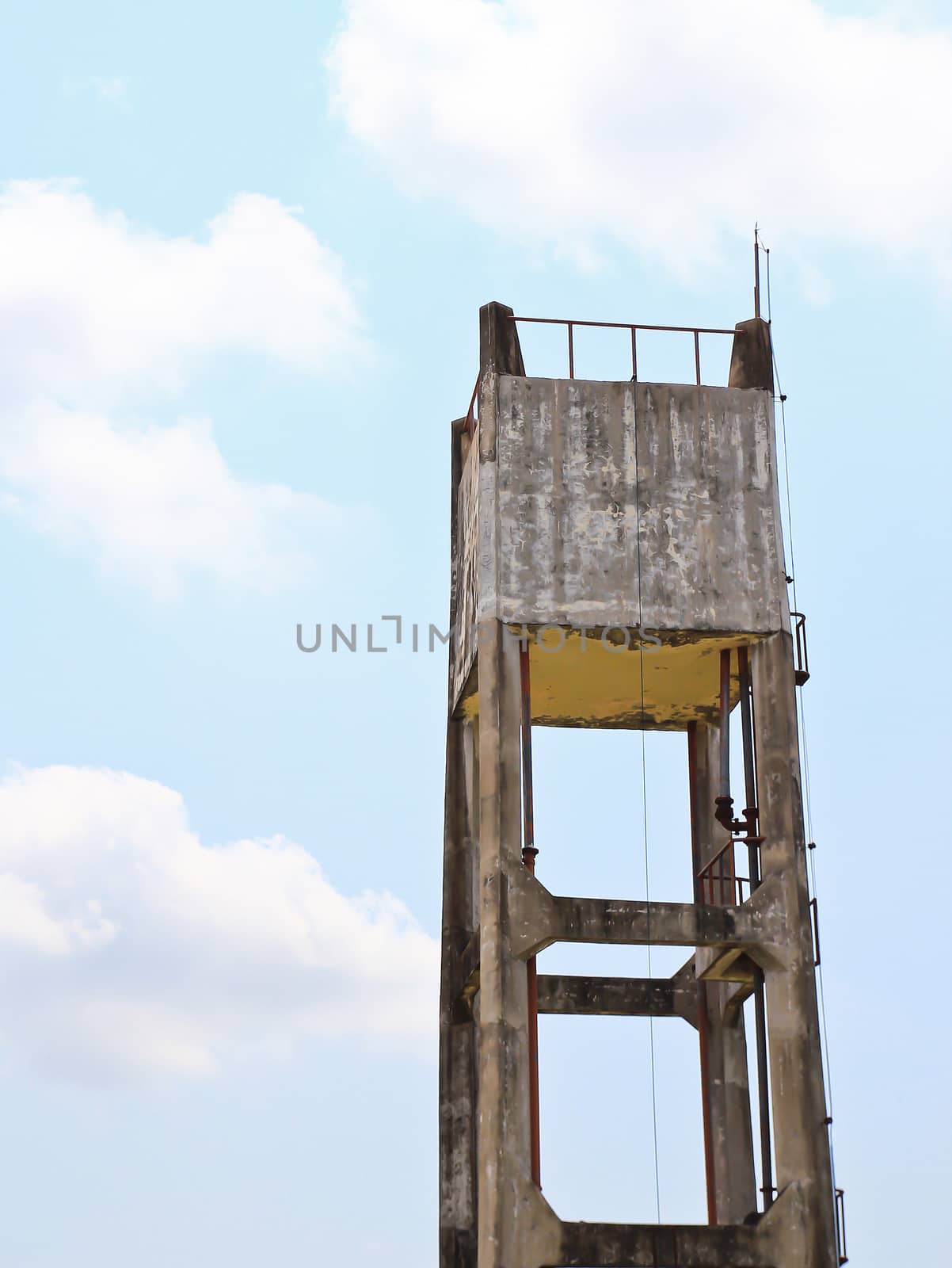 Concrete water tower against blue sky