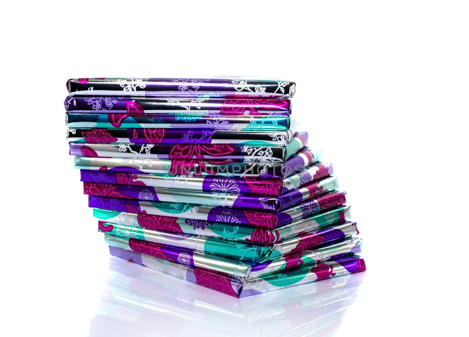 stack of presents in pink silver and green isolated on white background