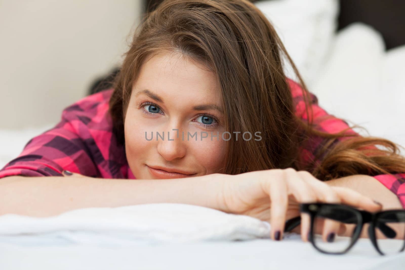 Cute young girl in casual relaxing on the bed