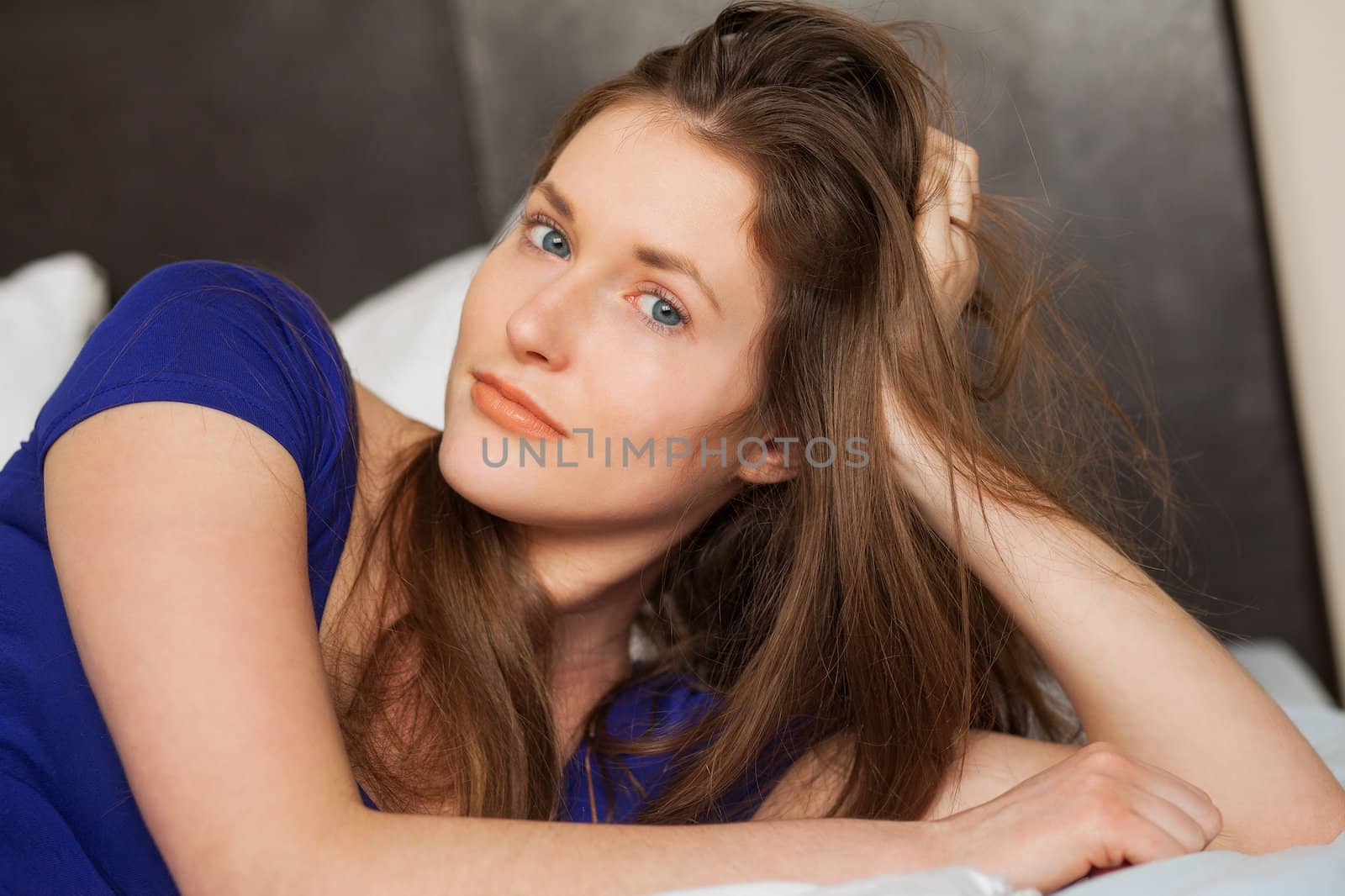 Beautiful caucasian girl lying in the bed relaxed