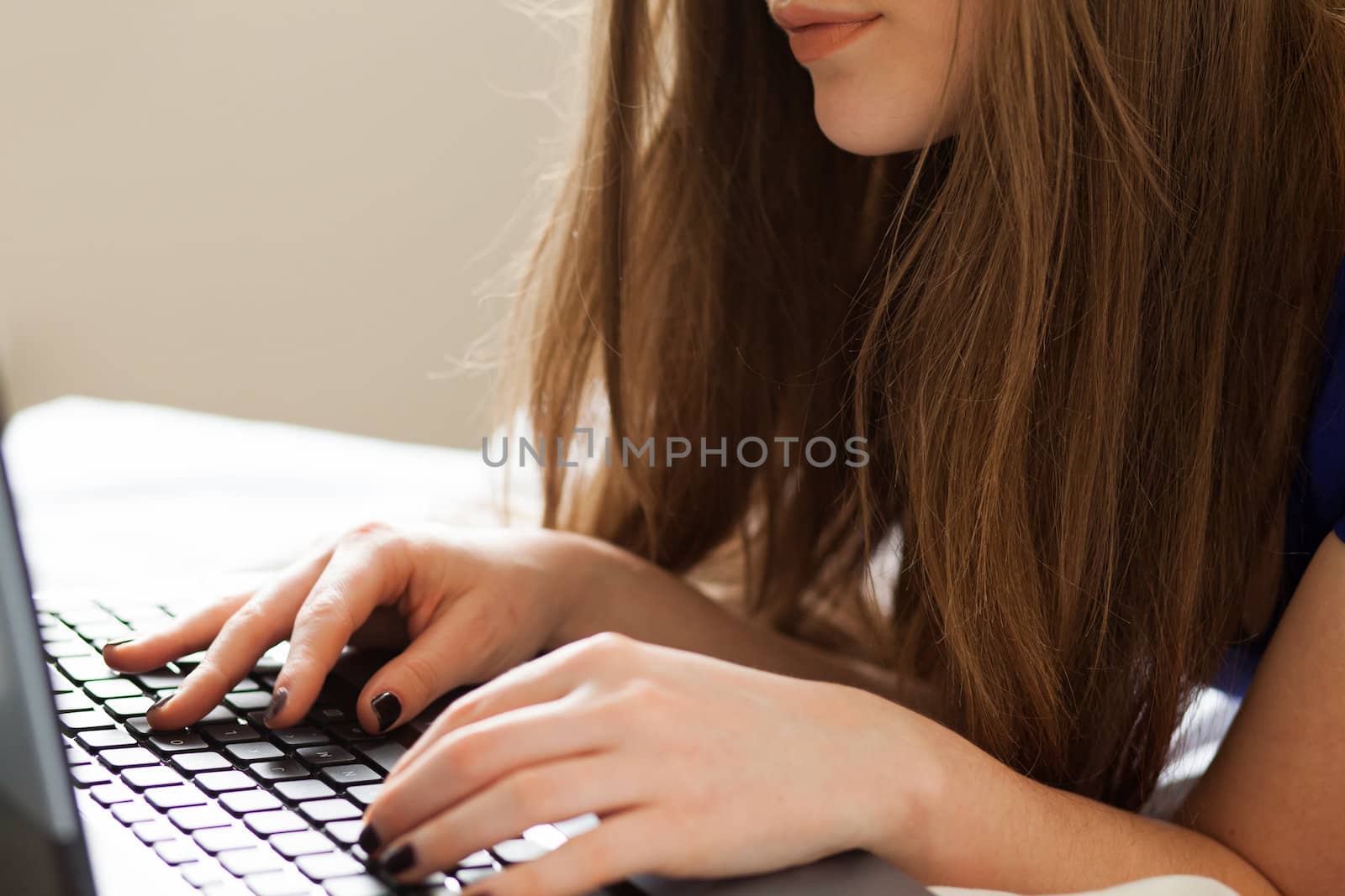 Woman's hands on notebook keyboard by rufatjumali