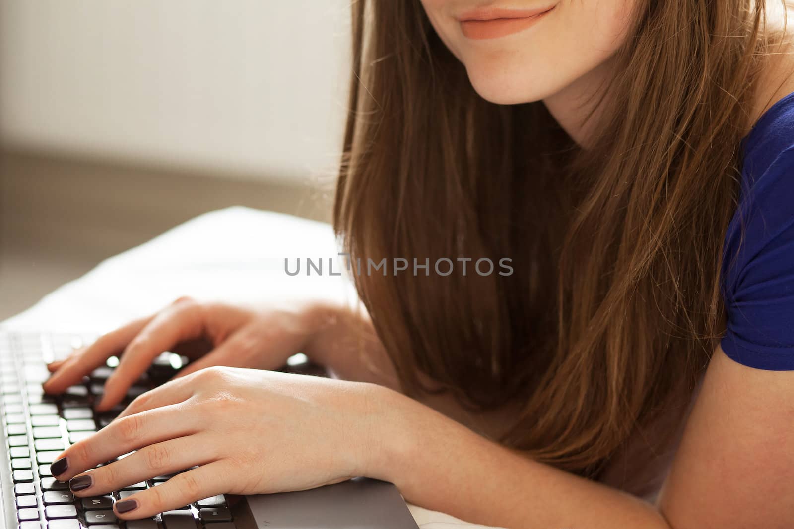 Woman's hands on notebook keyboard by rufatjumali