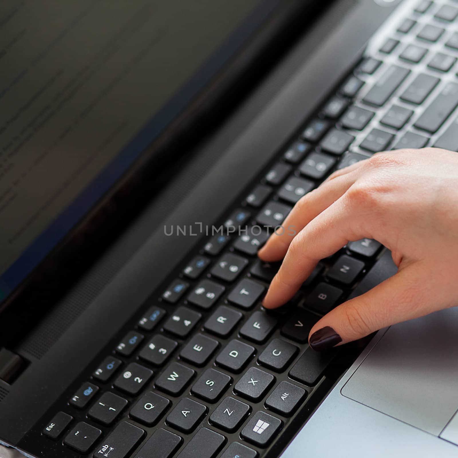 Woman's hands on notebook keyboard by rufatjumali