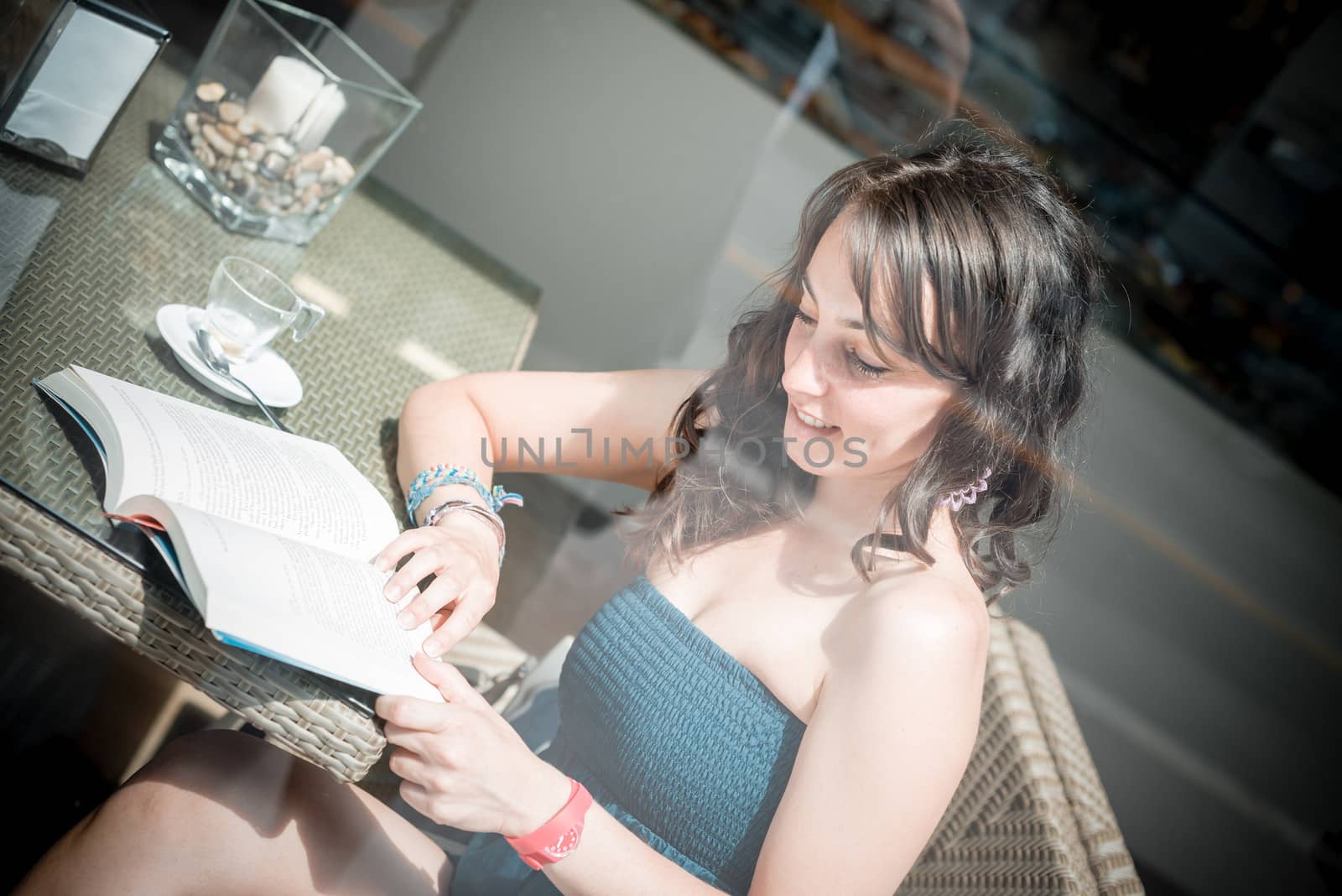 young beautiful woman reading book at the coffee