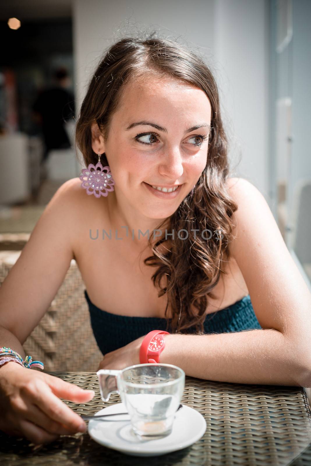 young beautiful woman drinking coffee by peus