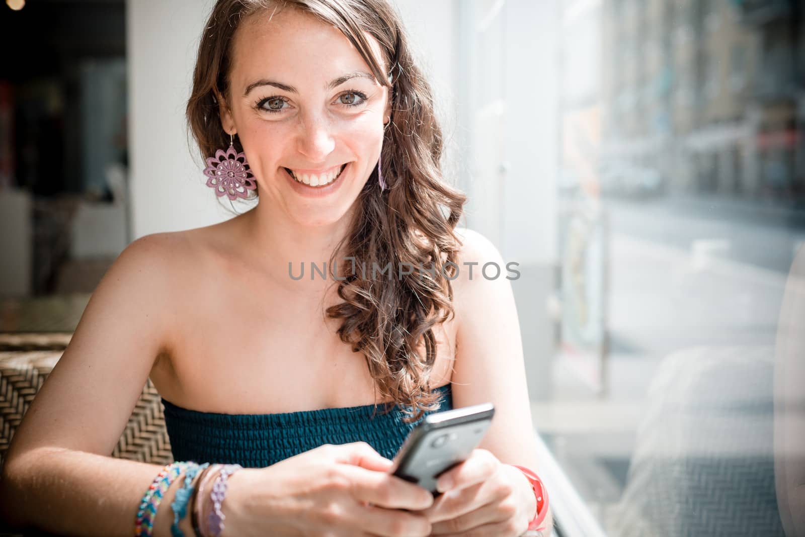 young beautiful woman on the phone at the coffee