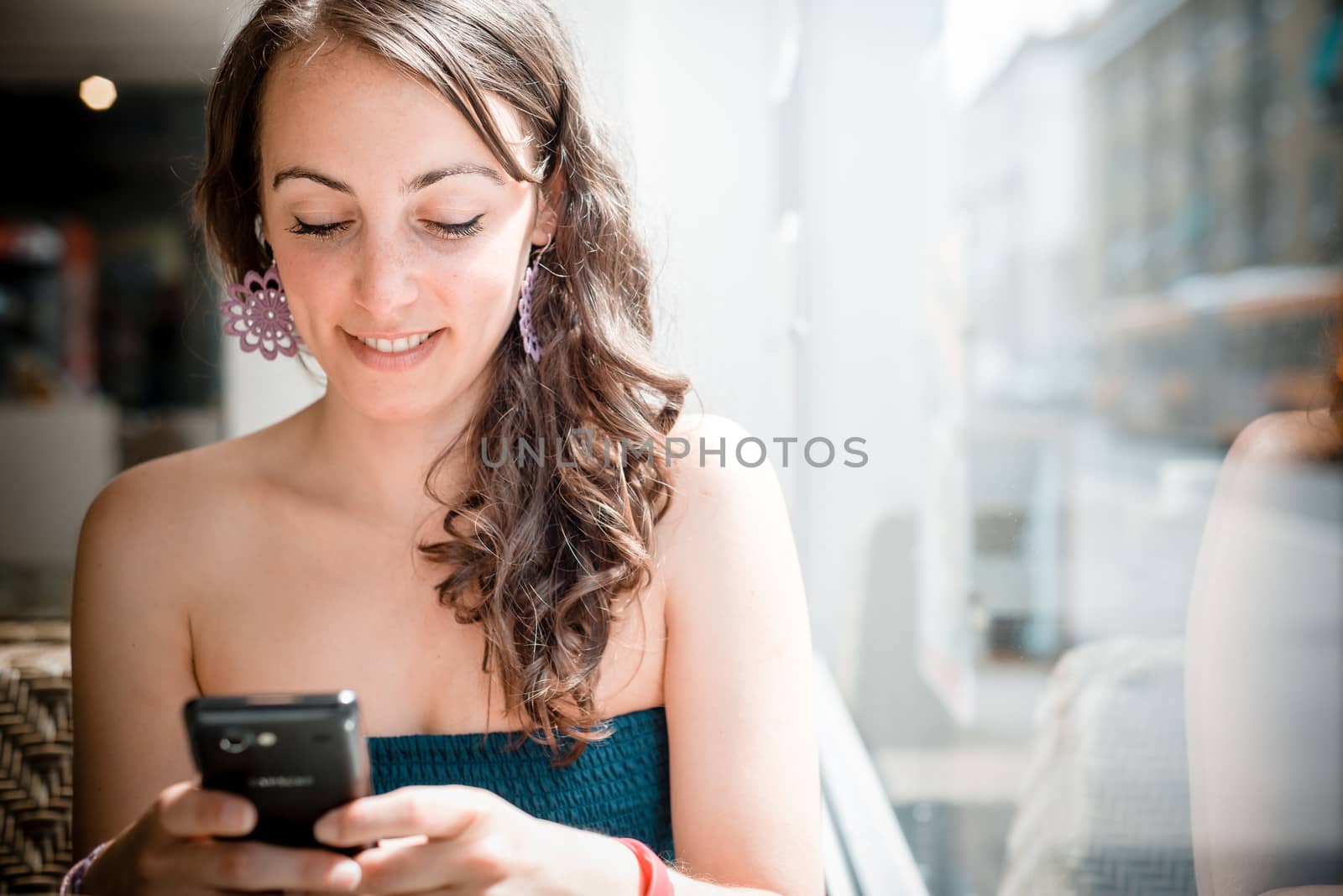 young beautiful woman on the phone at the coffee