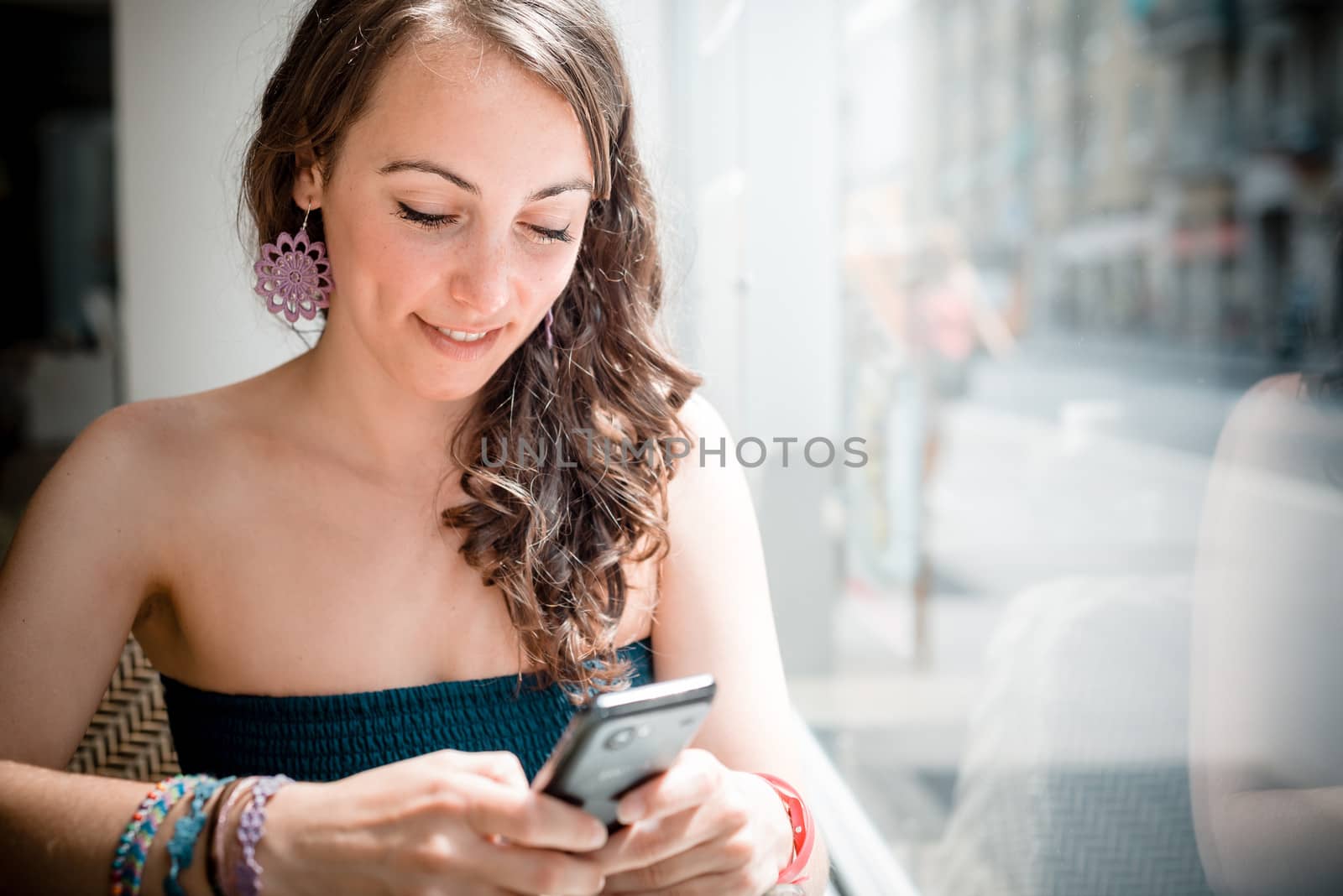 young beautiful woman on the phone at the coffee