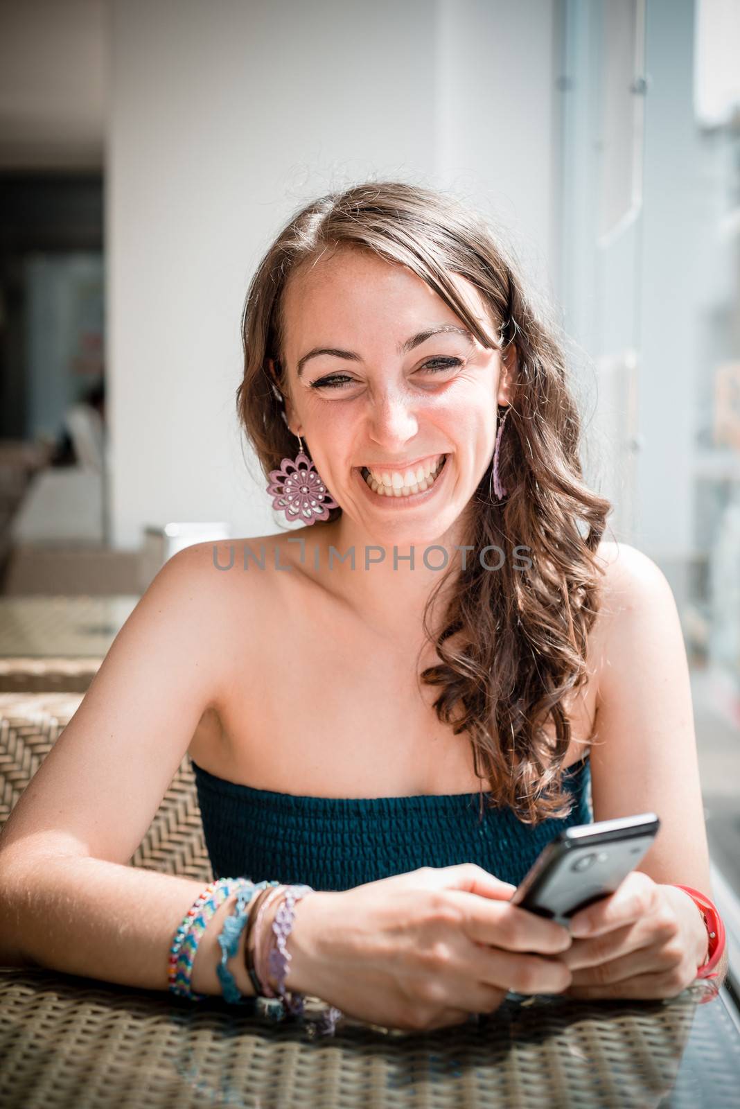 young beautiful woman on the phone at the coffee