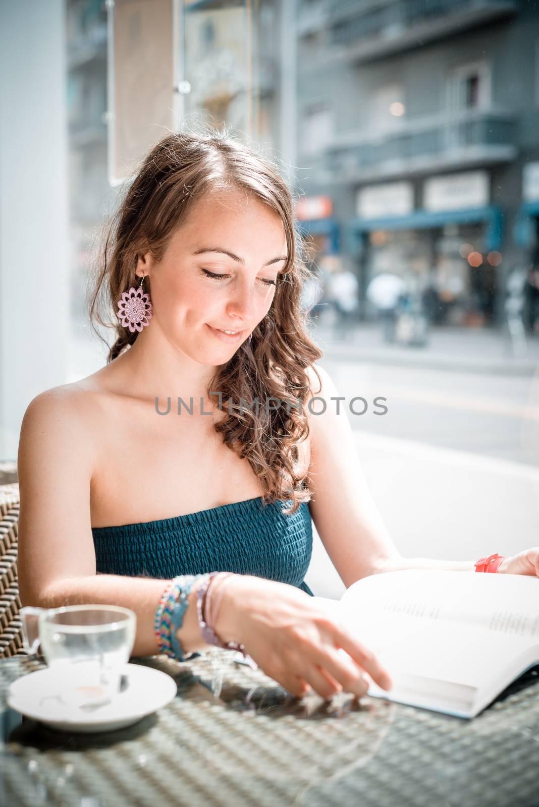 young beautiful woman reading book at the coffee