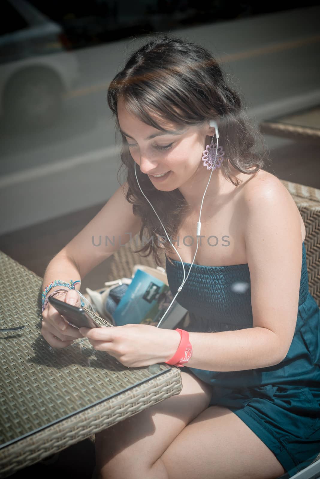 young beautiful woman listening to music at the coffee