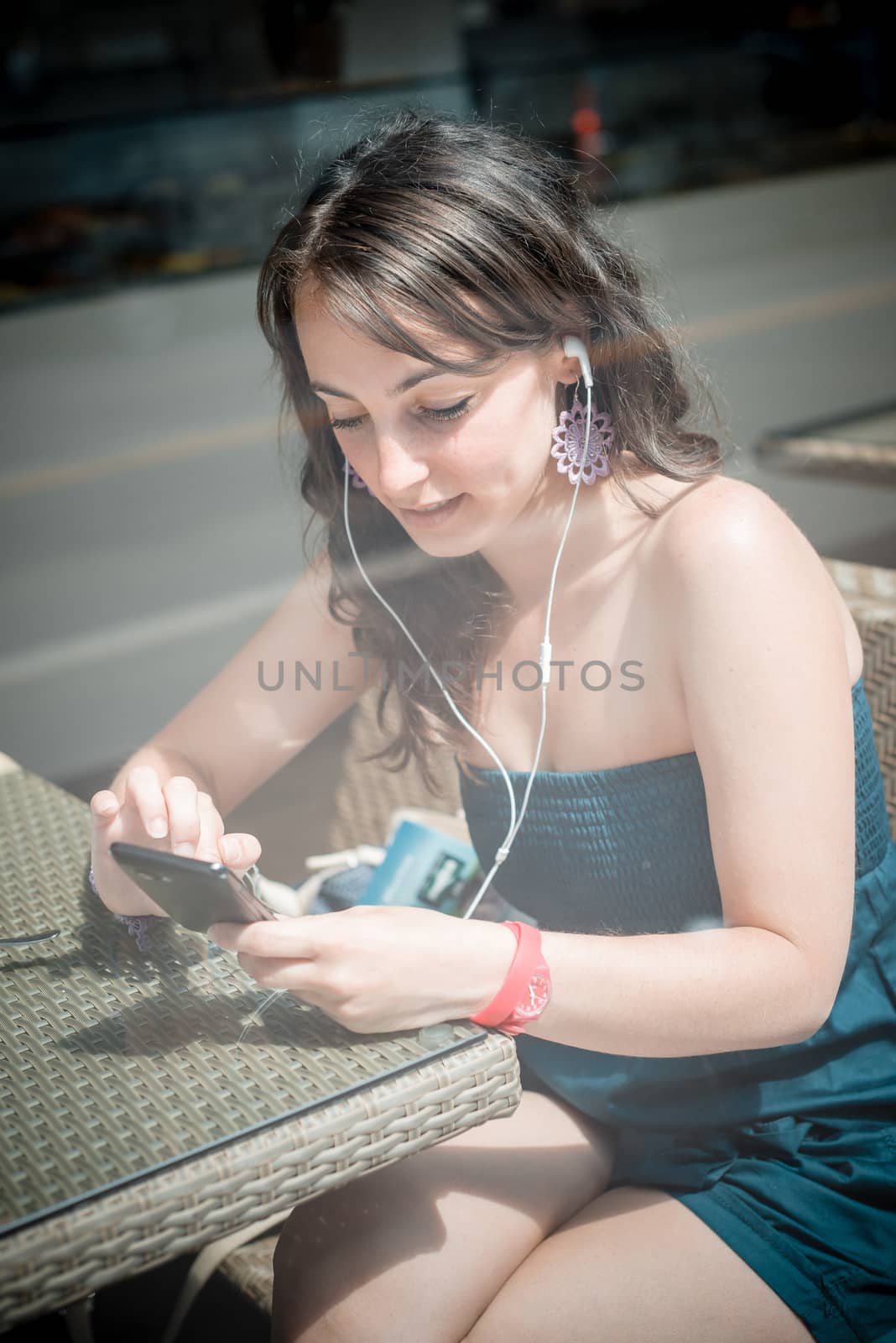 young beautiful woman listening to music by peus