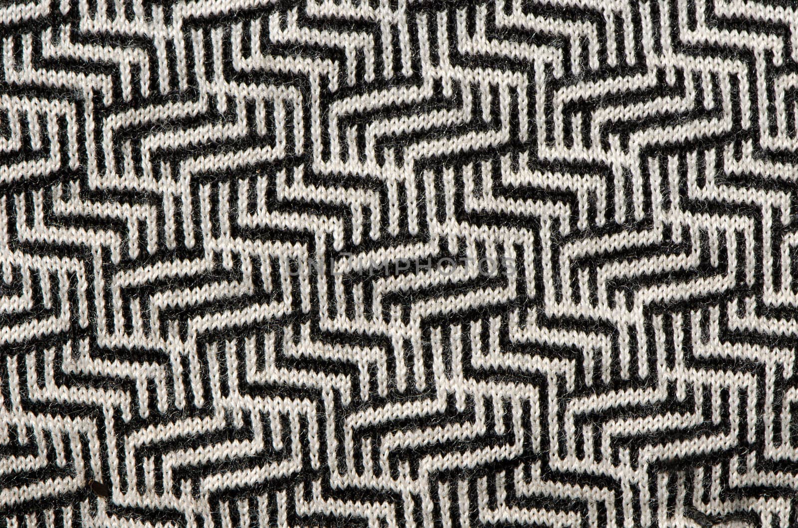 hand knit wool zigzag pattern texture black white backdrop.