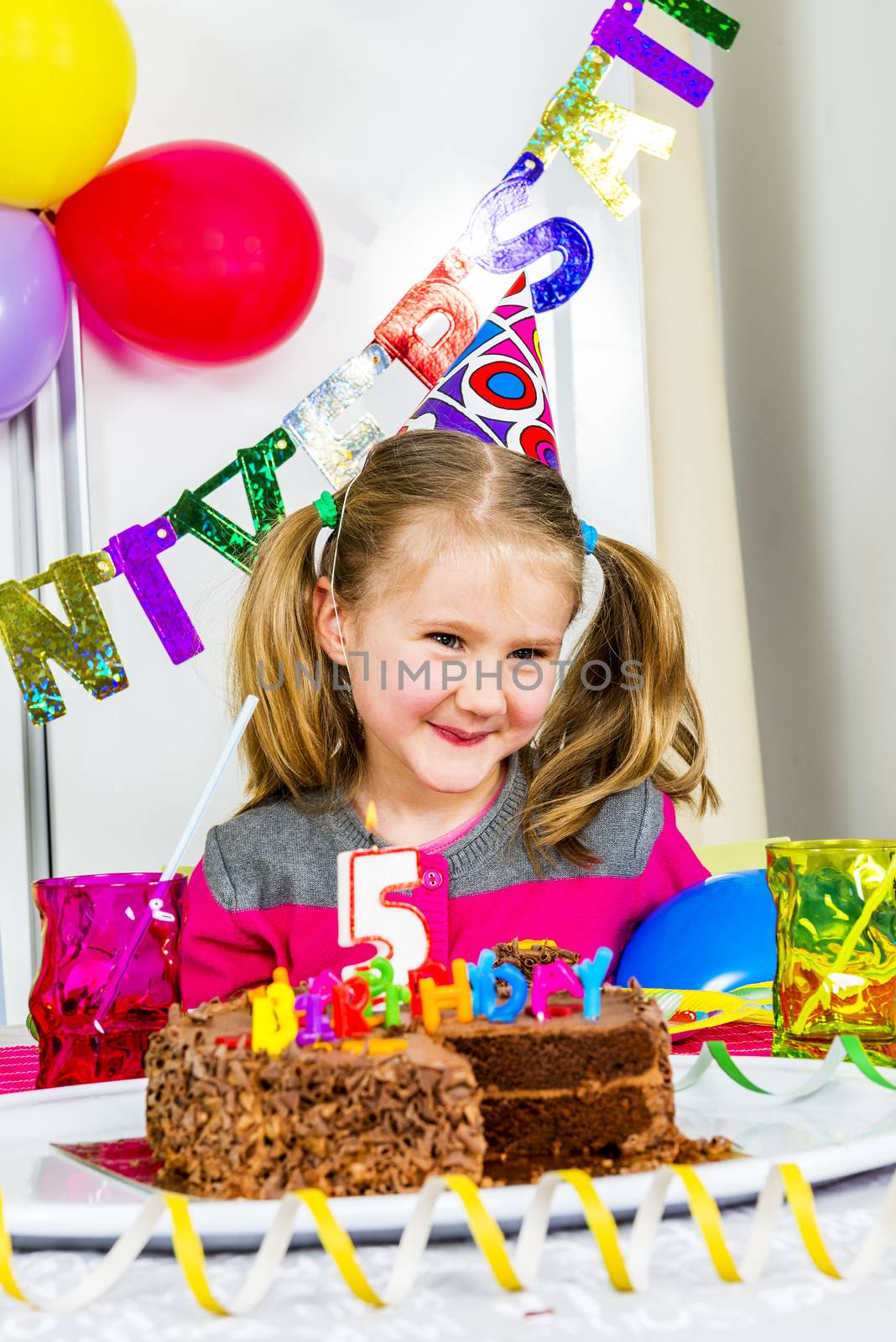 Happy little girl how have fun in a birthday party 