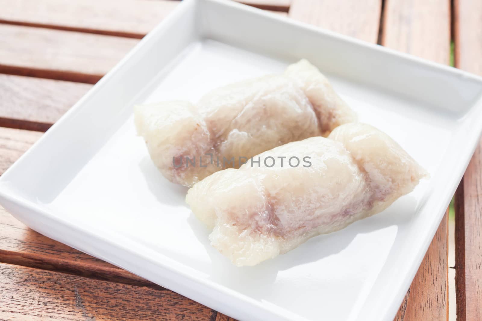 Bunch of mush with banana filling on white dish by punsayaporn