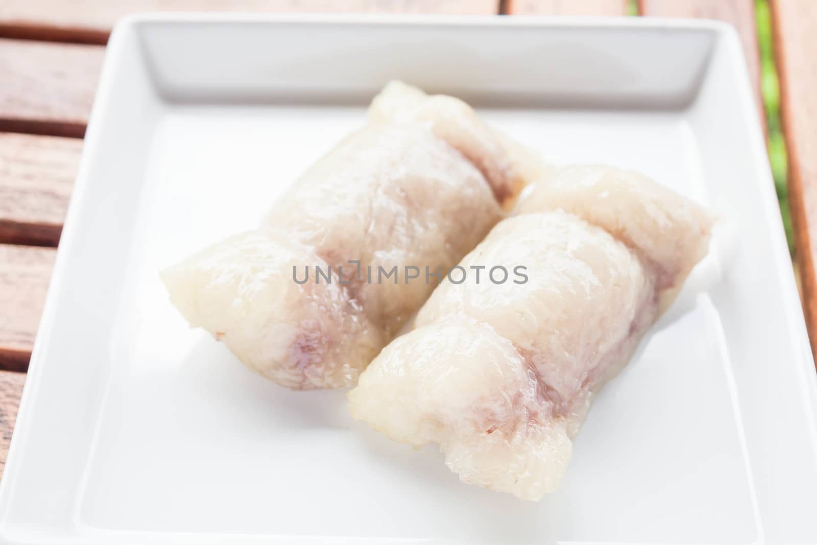 Bunch of mush with banana filling on white plate by punsayaporn